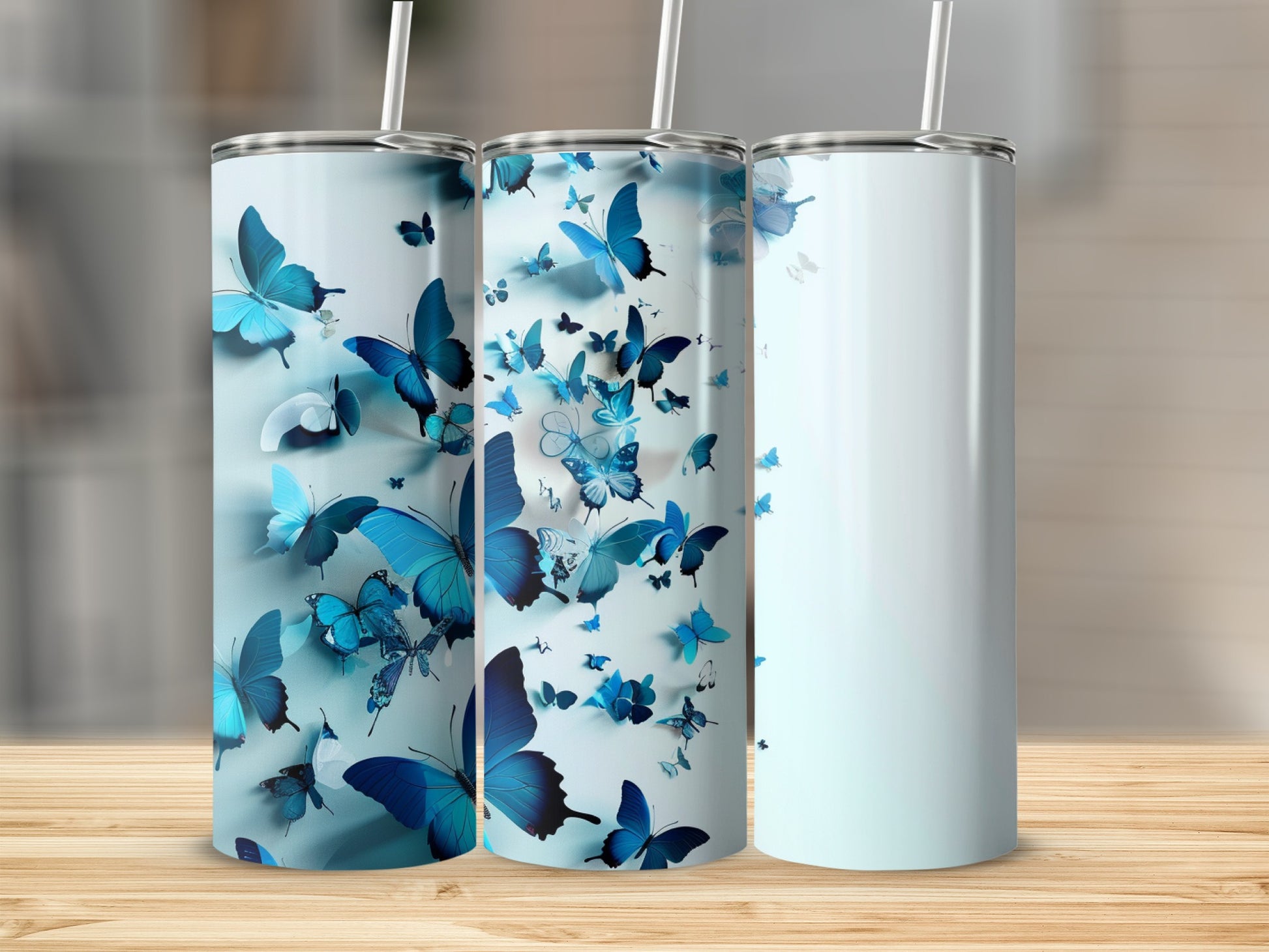 Blue butterfly pattern on a set of three tall, insulated tumblers.