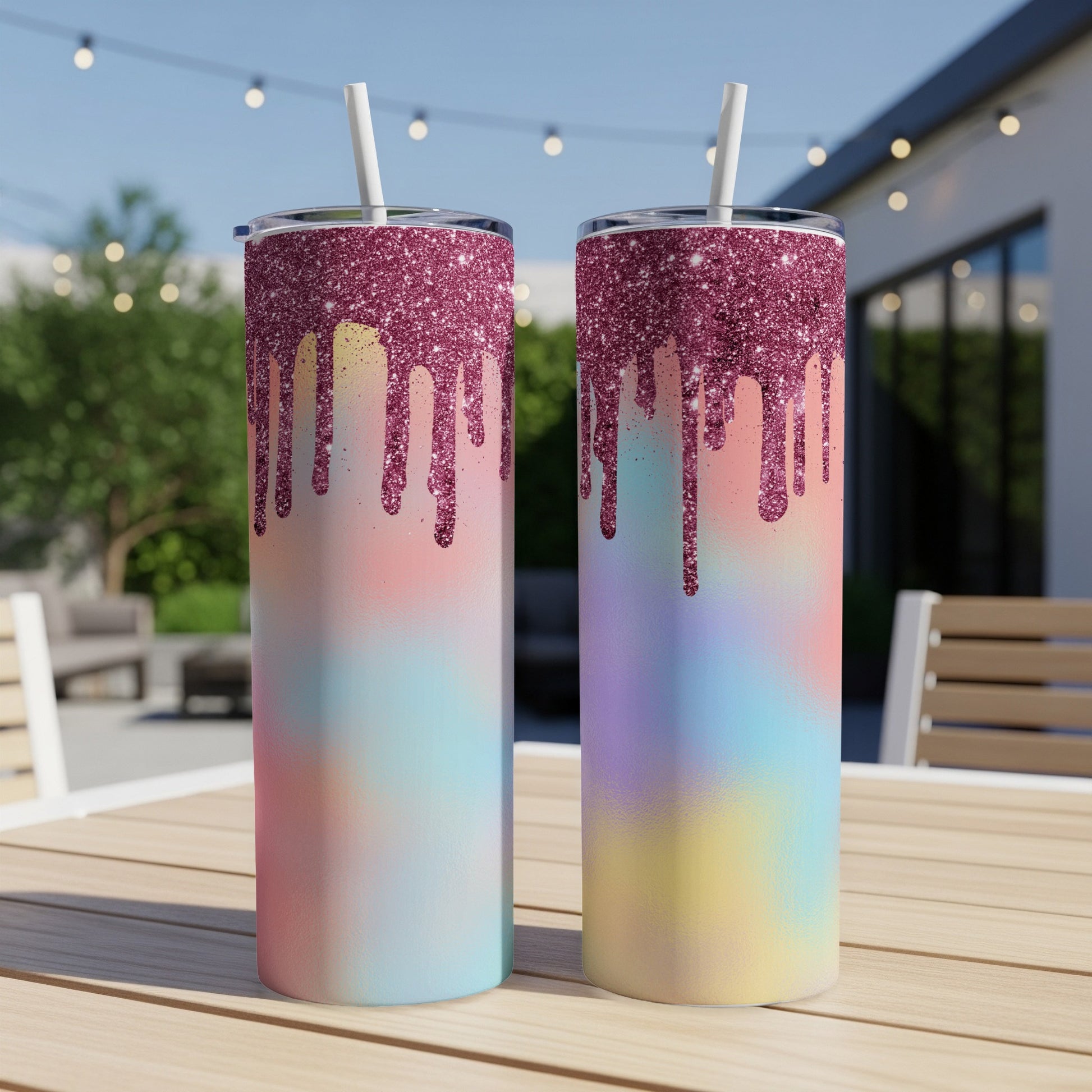 Two tumblers with pink glitter drip and pastel ombre design on wooden table.