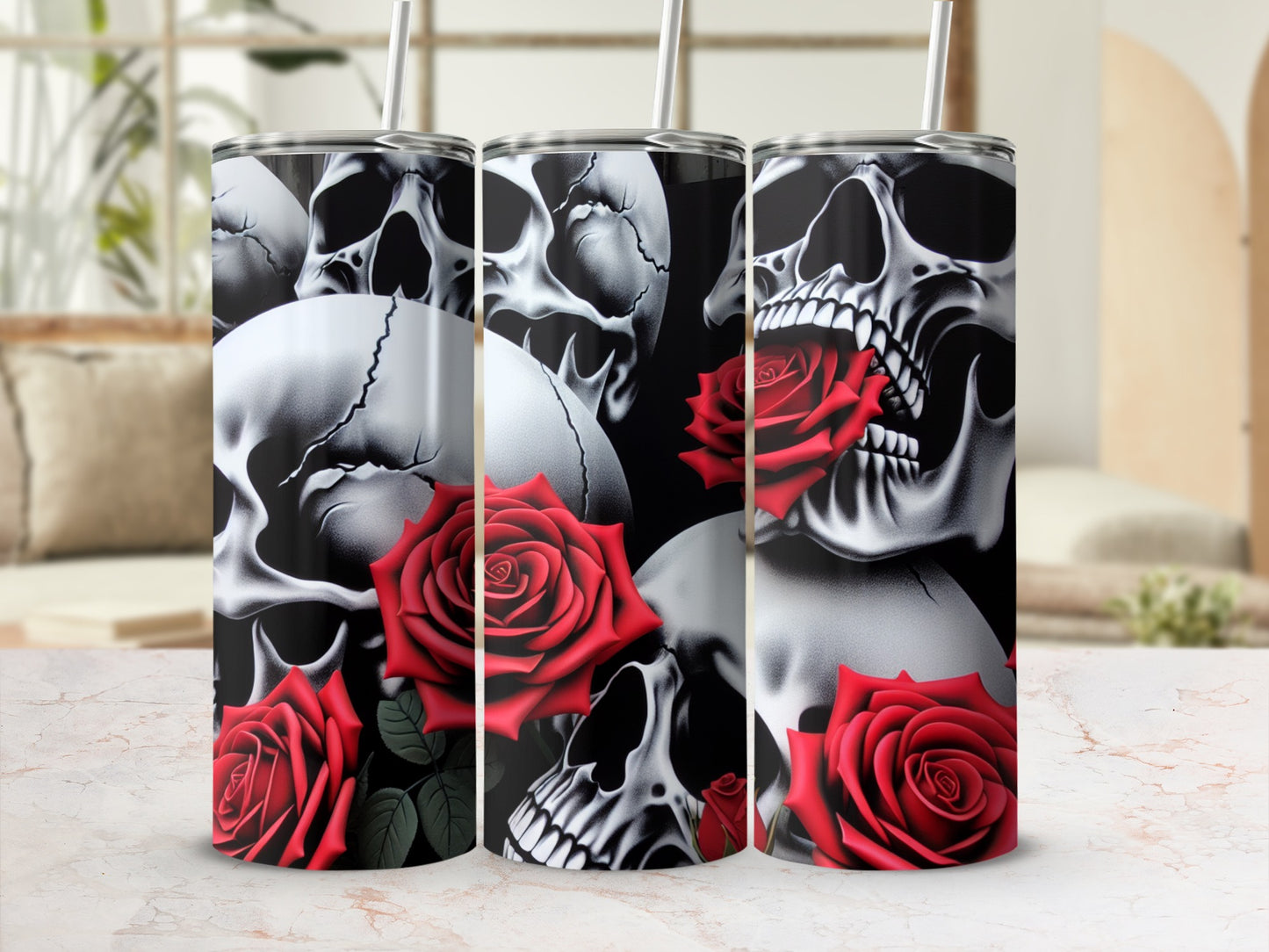 Three tumblers with skull and rose designs on a marble countertop.