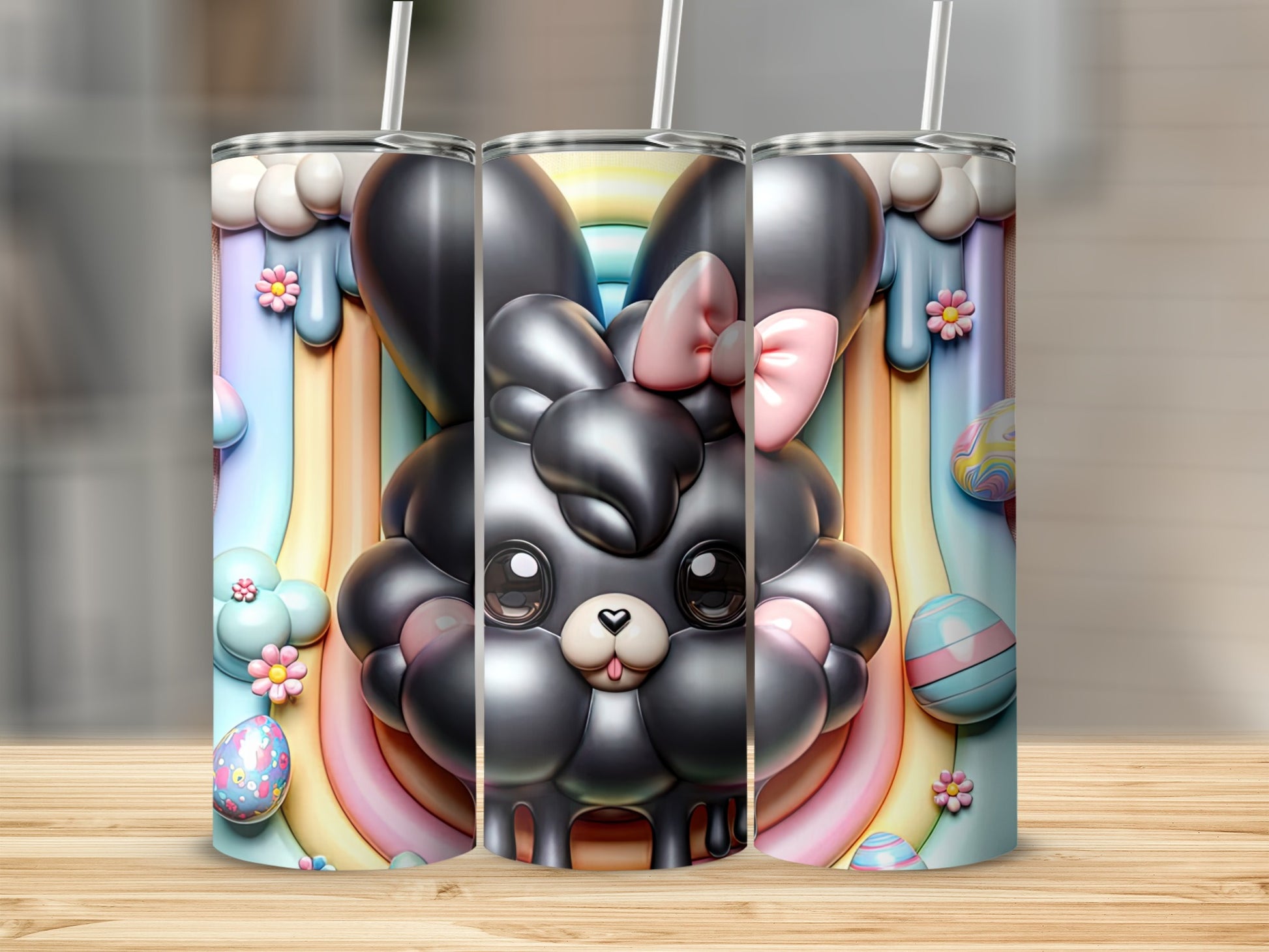 3D render of three bunny-themed tumblers with colorful rainbow and Easter egg designs.