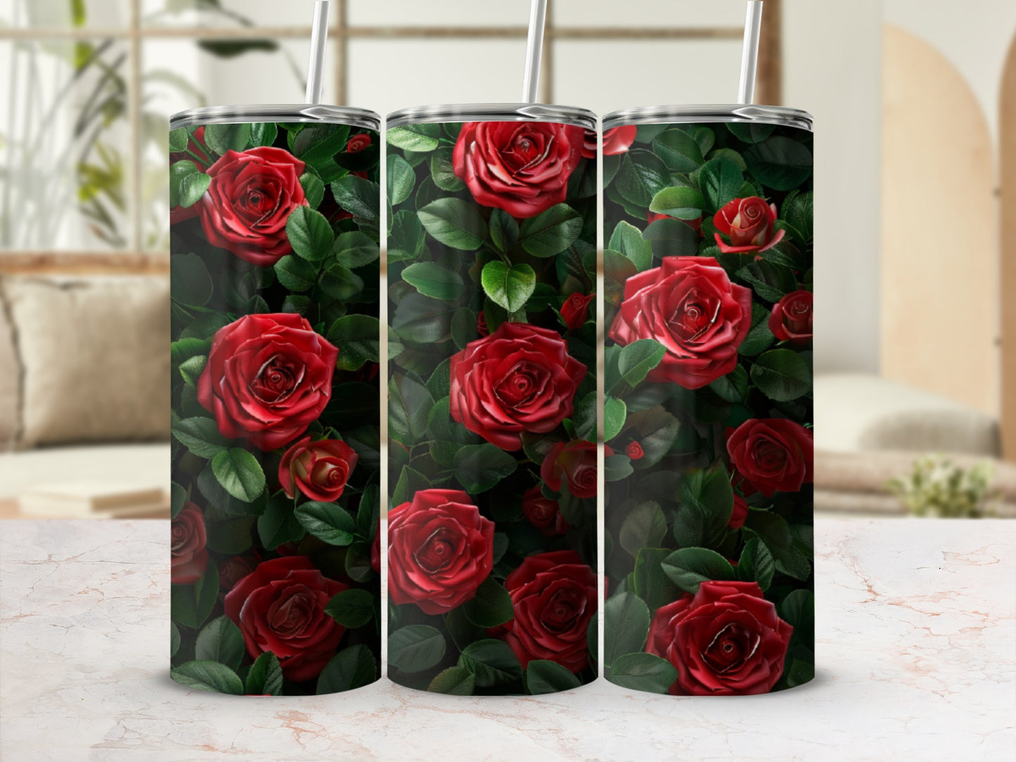 Three tumblers adorned with a pattern of red roses and green leaves.