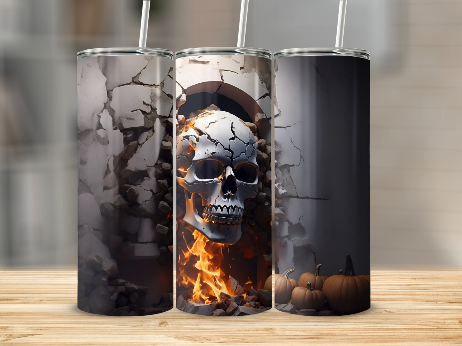 Three tumblers with Halloween designs: a cracked skull with fire, and pumpkins.