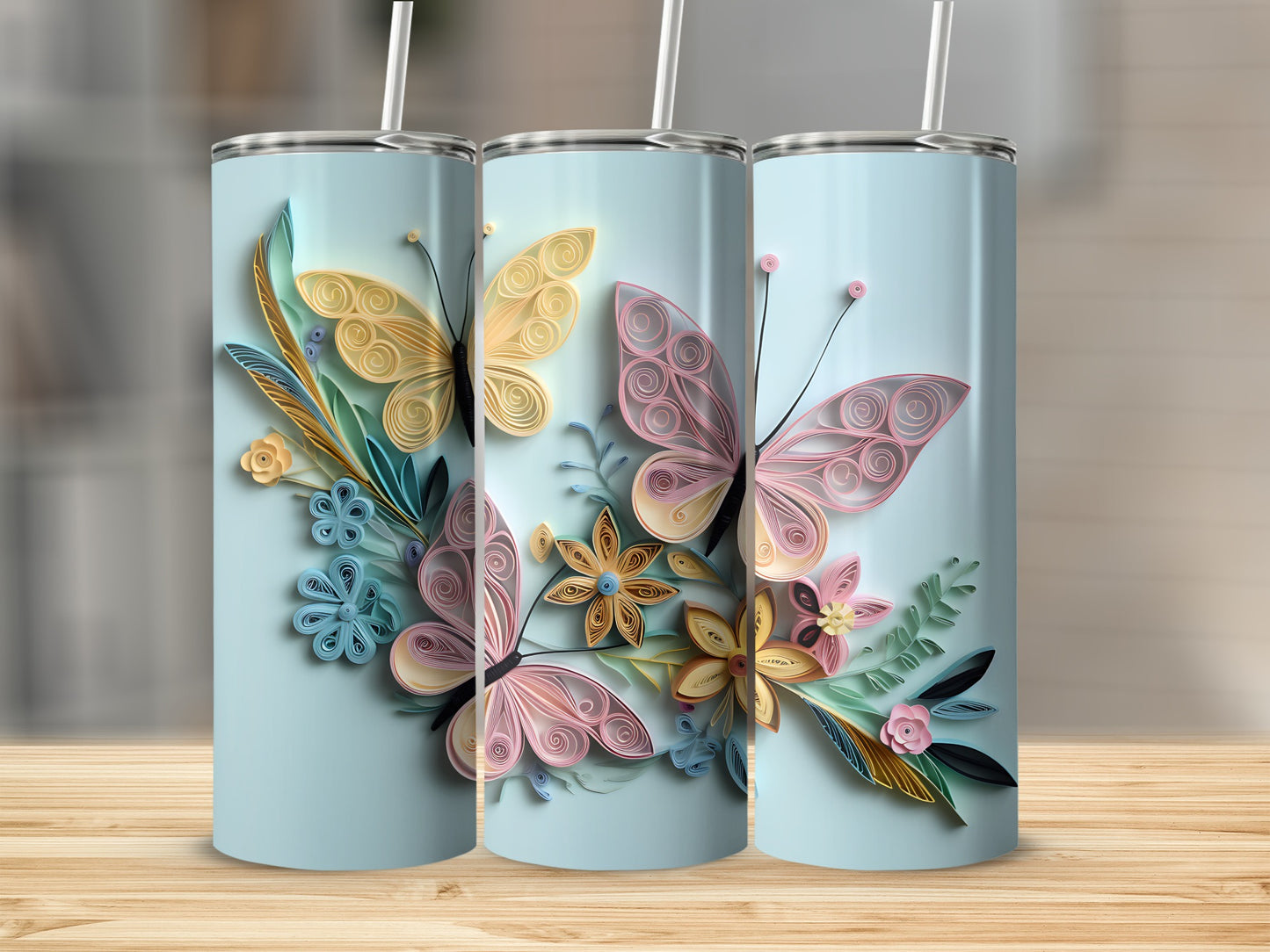 Light blue tumblers with pastel quilled butterflies and floral designs.