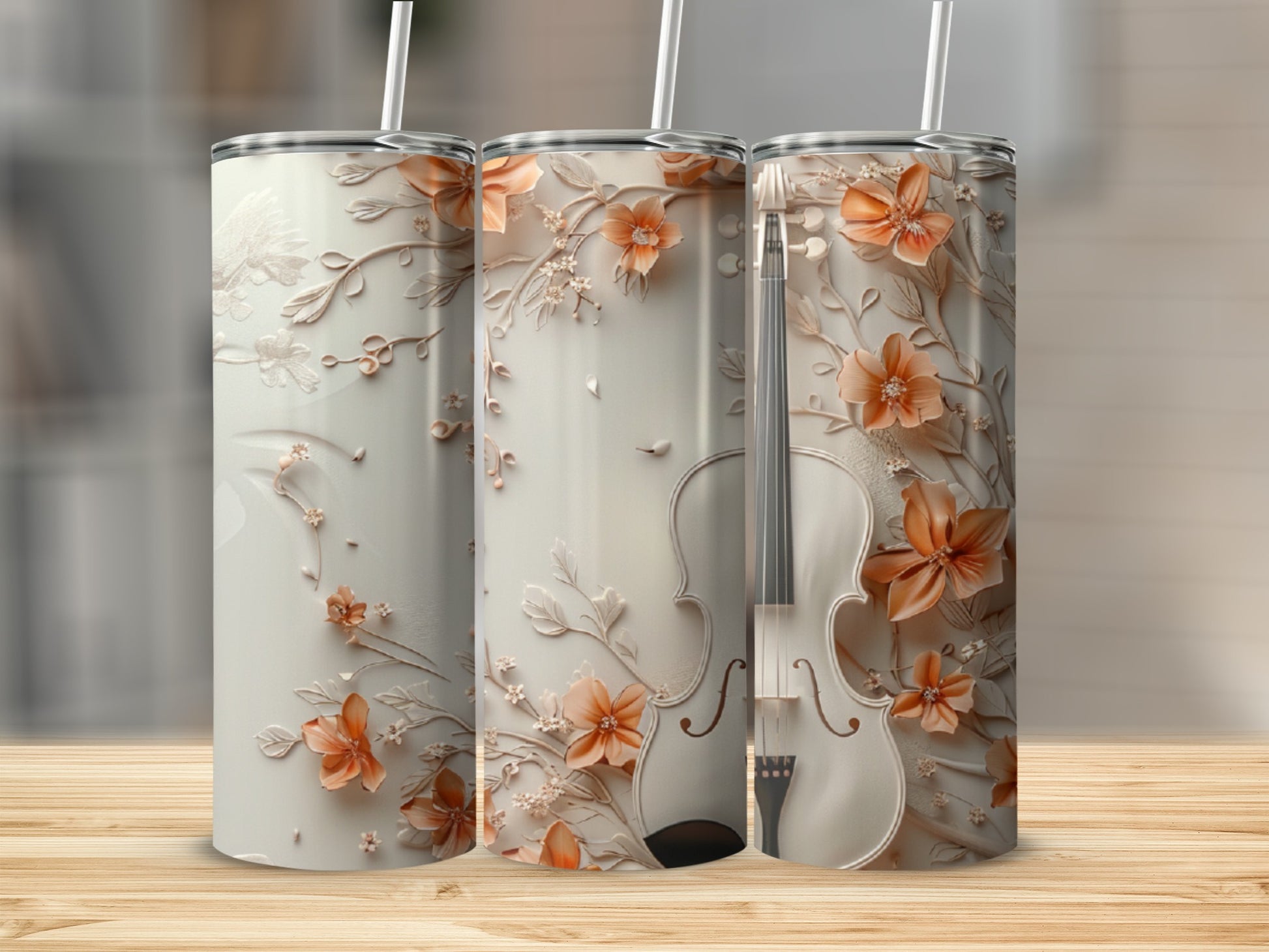 Three tall tumblers with floral and violin designs, displayed on a wooden surface.
