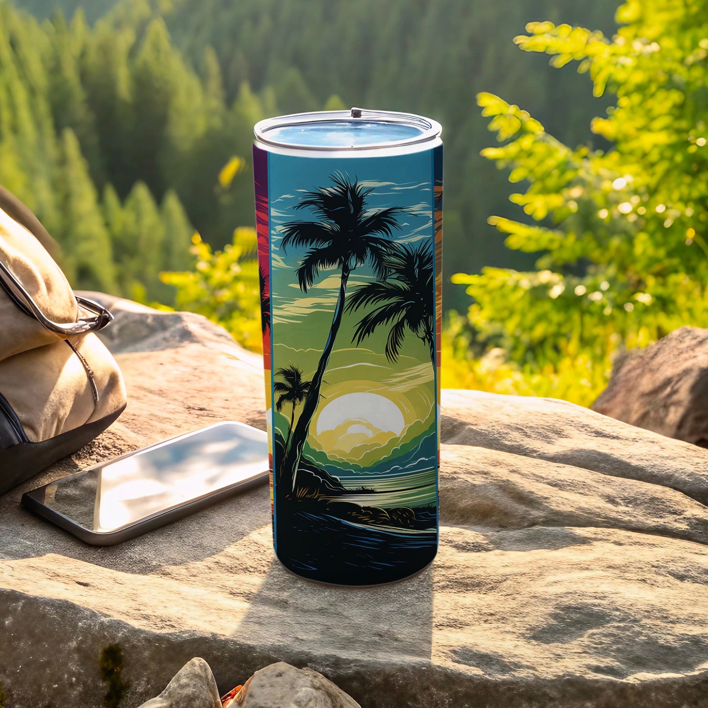 Tall tumbler with a sunset beach scene design, resting on rocks.