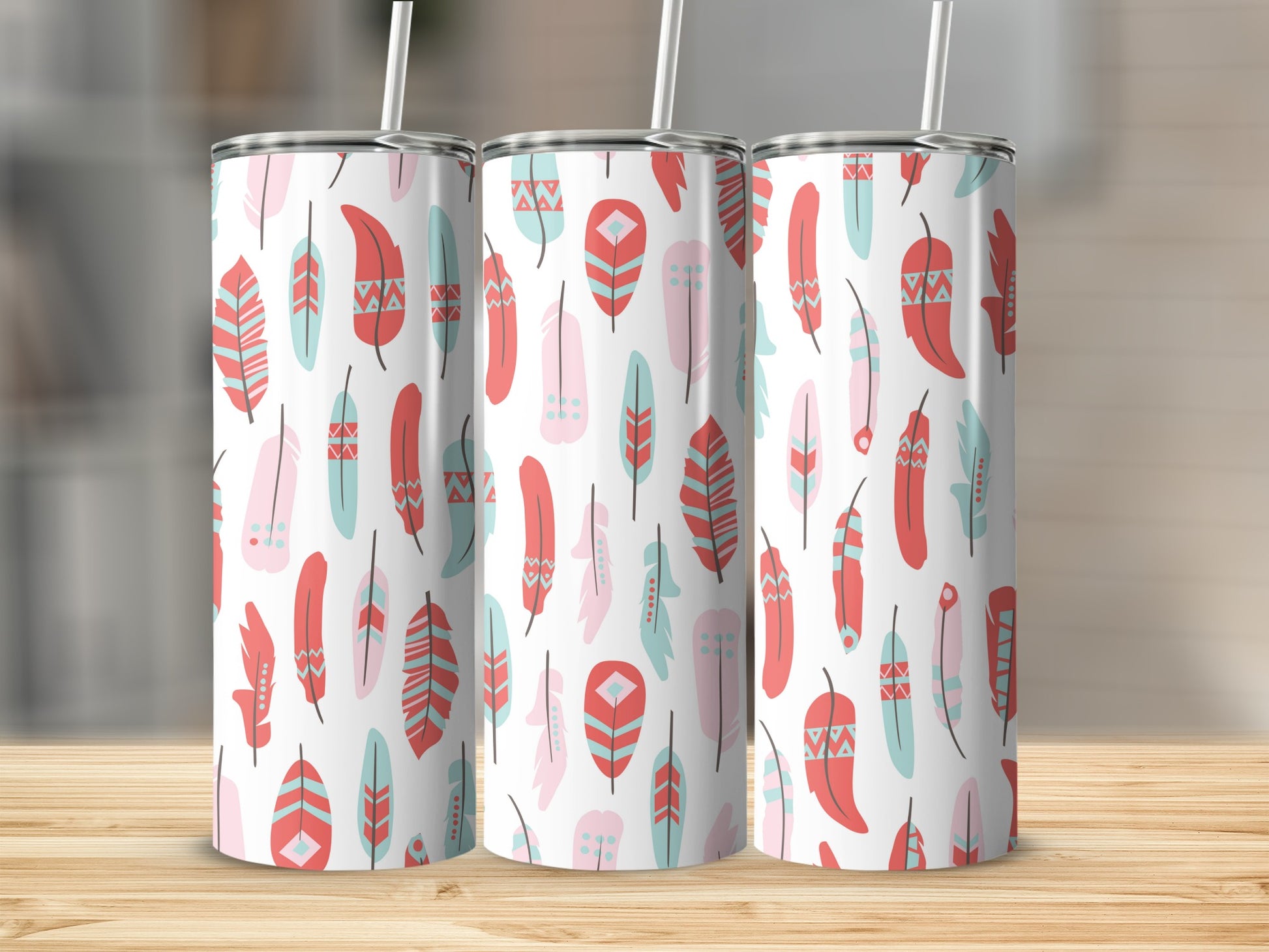 Three tumblers with a pink, teal, and red feather pattern.