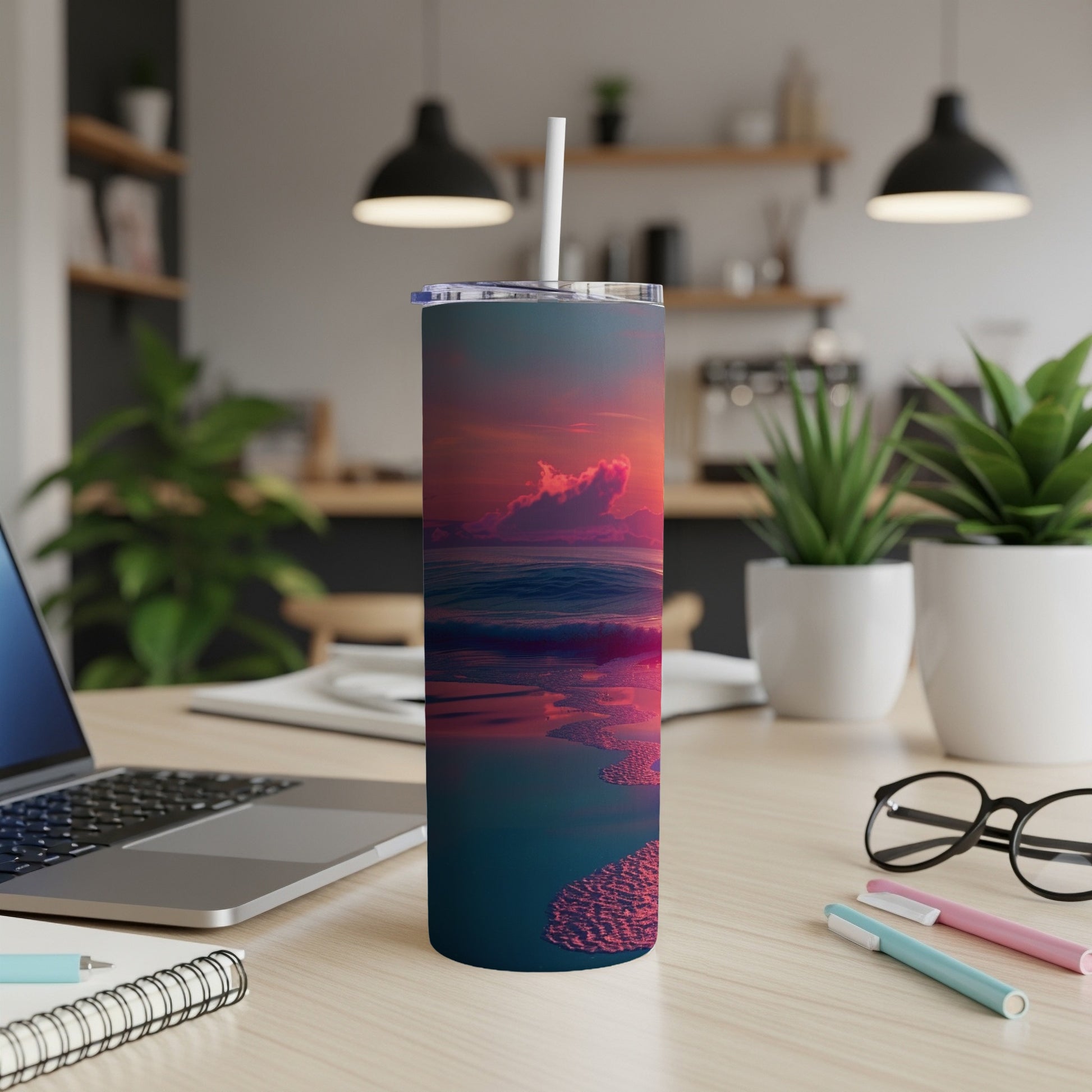 Sunset ocean waves and sandy shore design on a tumbler with straw.