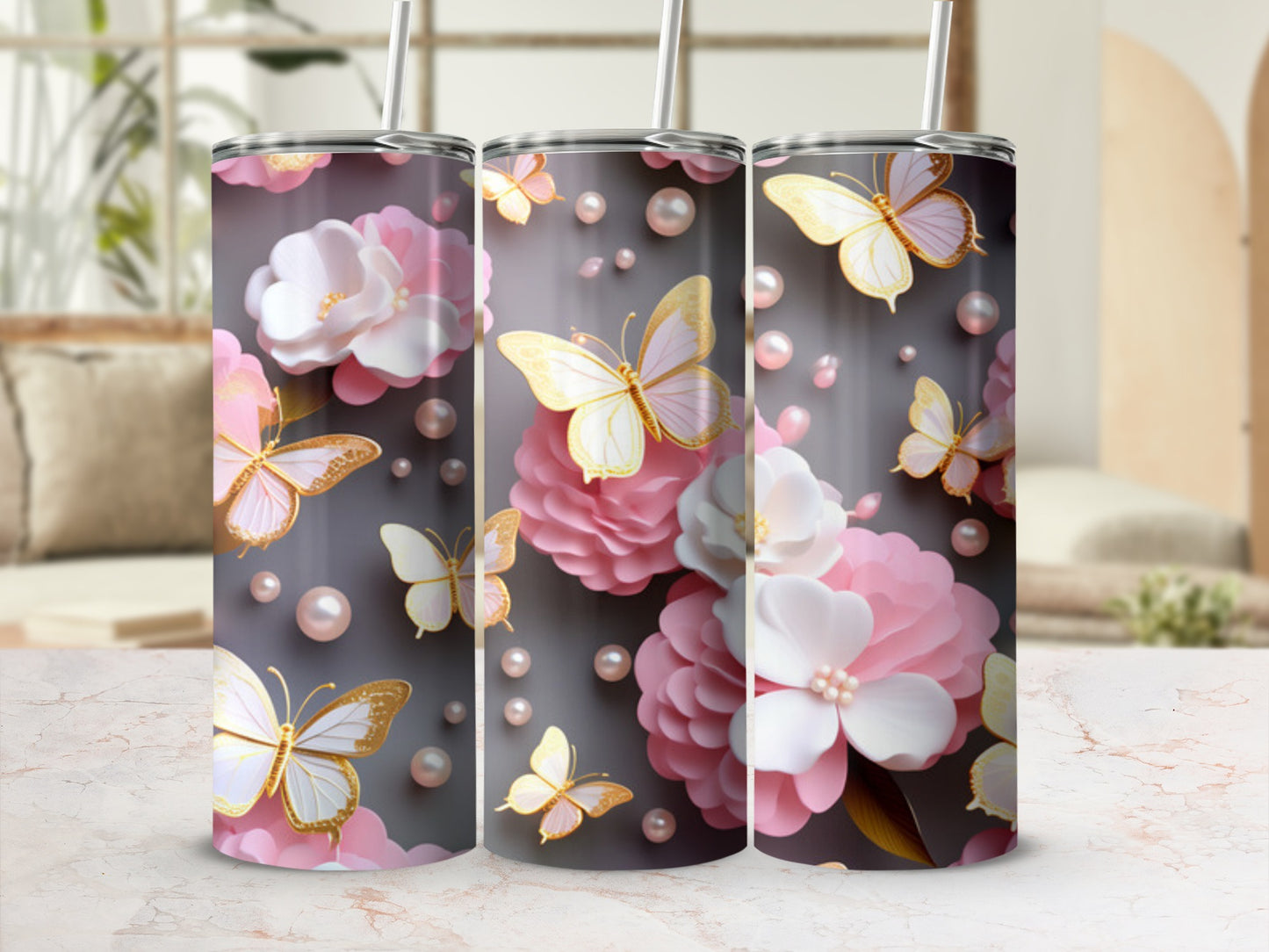 Three tumblers with pink flowers and golden butterflies on a gray background.