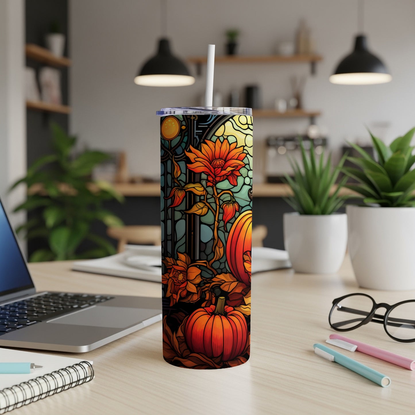 Pumpkin and floral stained glass design on a tumbler, with a straw.