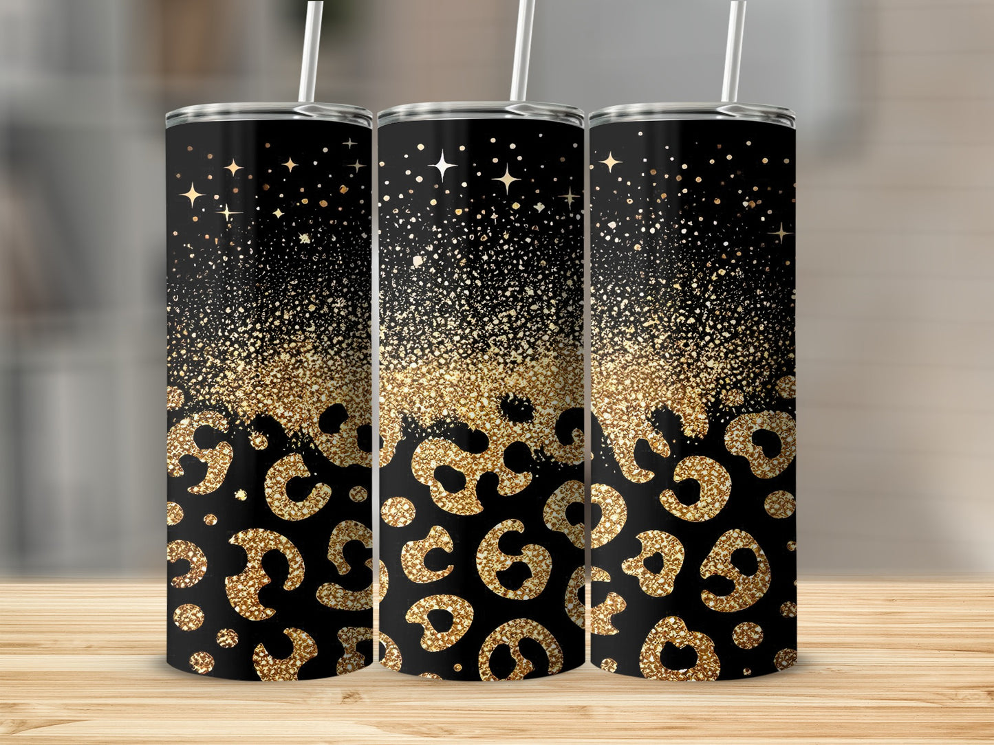 Three black tumblers with gold glitter leopard print and starry accents.