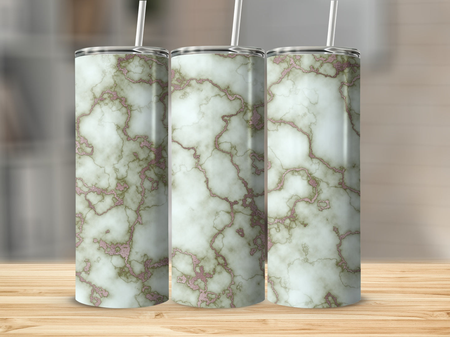 Three tumblers with white and gold marble pattern, standing on a wooden surface.