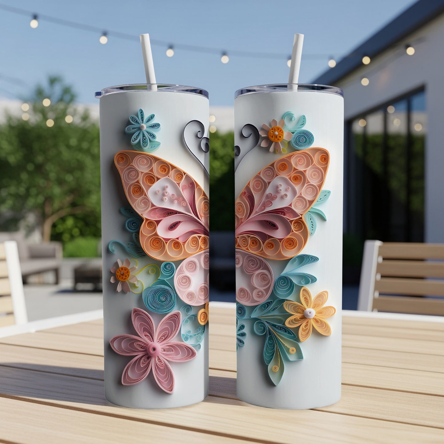 Two white tumblers with colorful butterfly and floral quilling designs.