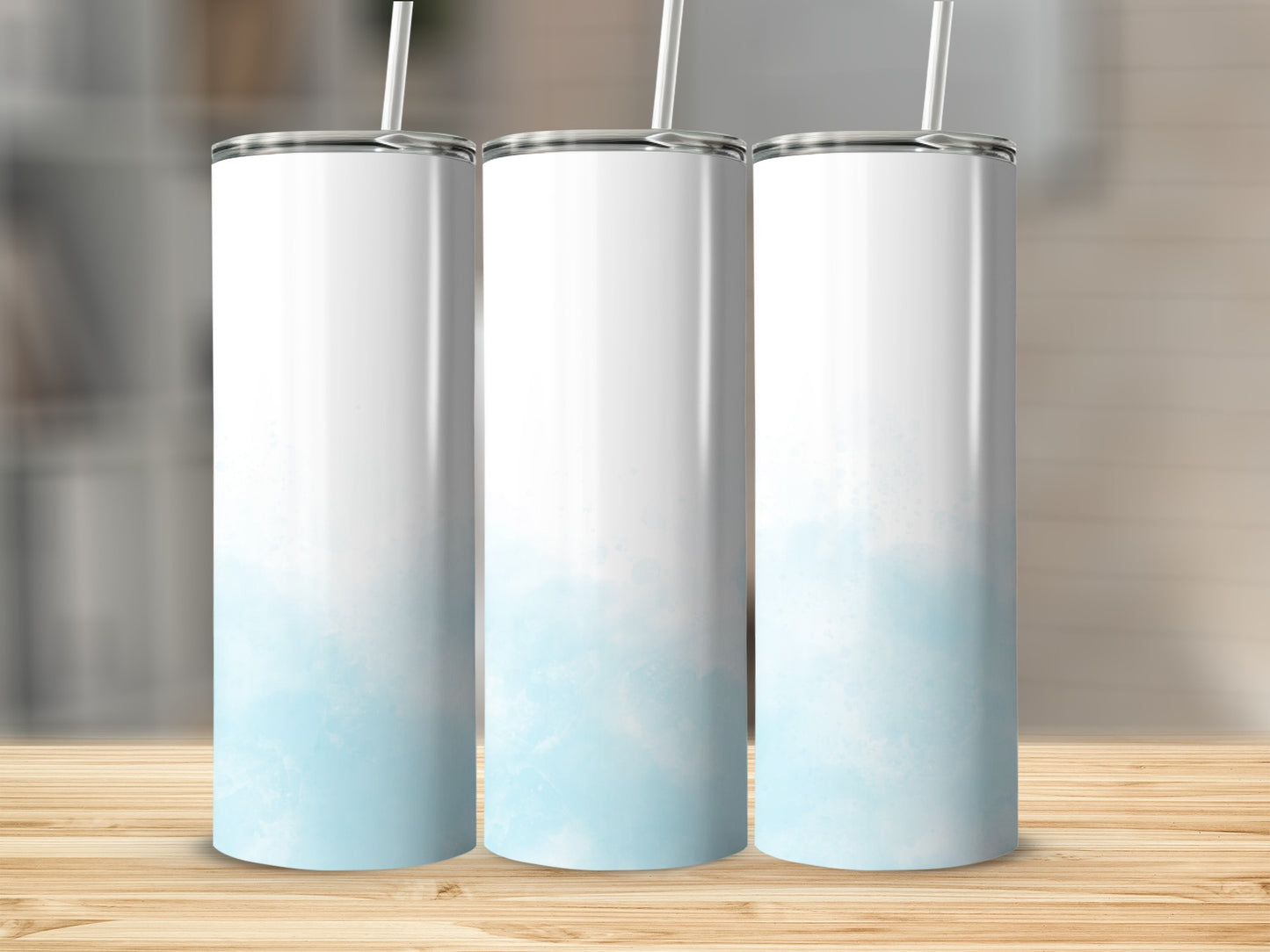 Three blank white tumblers with light blue watercolor designs.