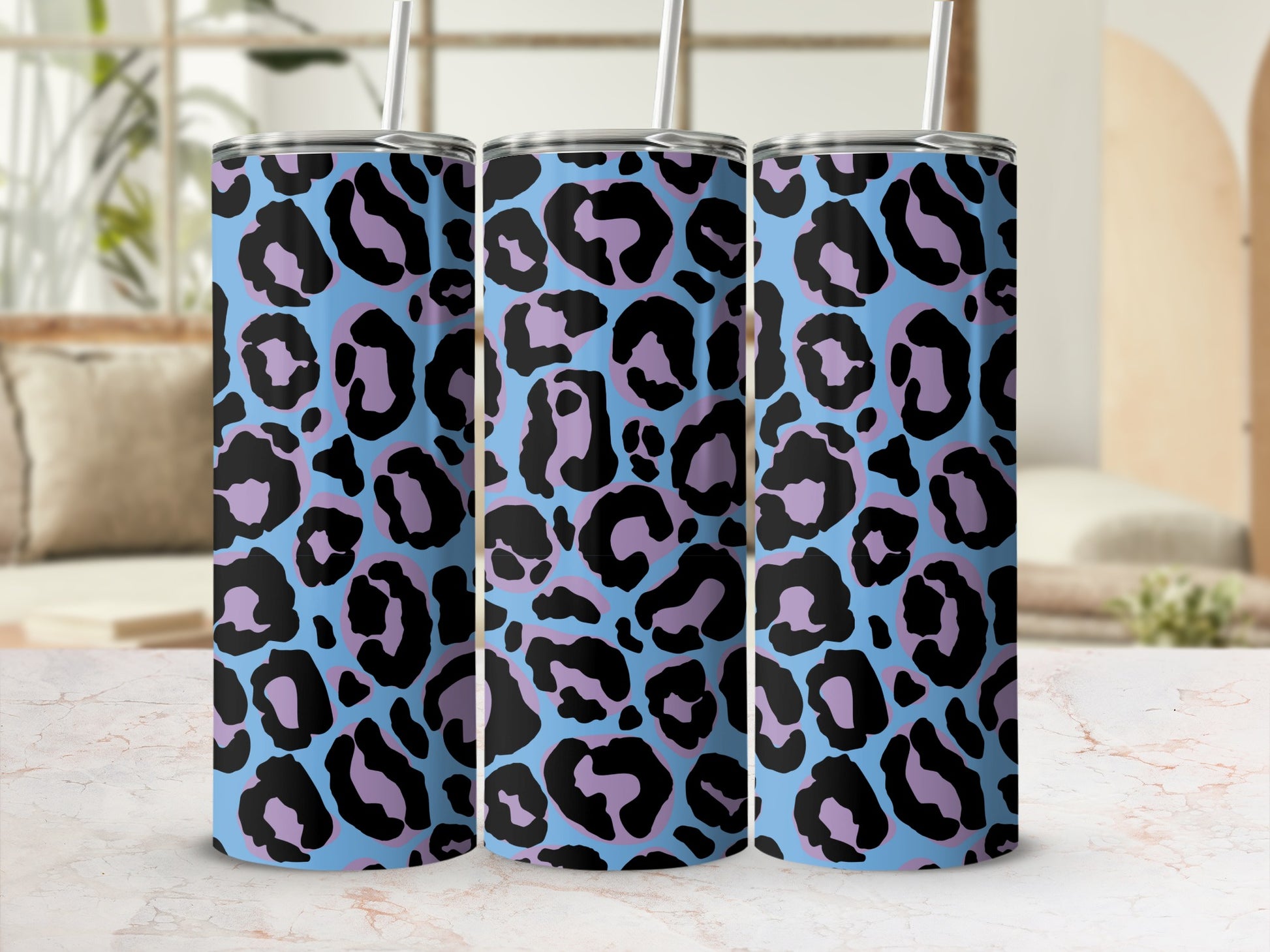 Three tumblers with a blue background and black and lavender leopard print pattern.
