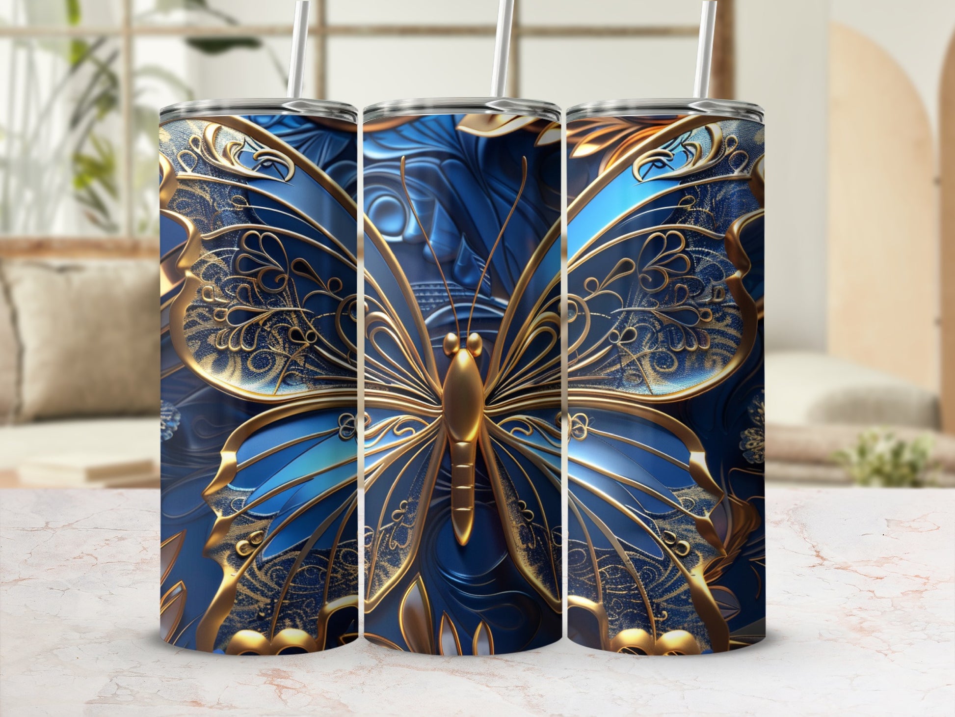 Three tall tumblers with ornate blue and gold butterfly designs.