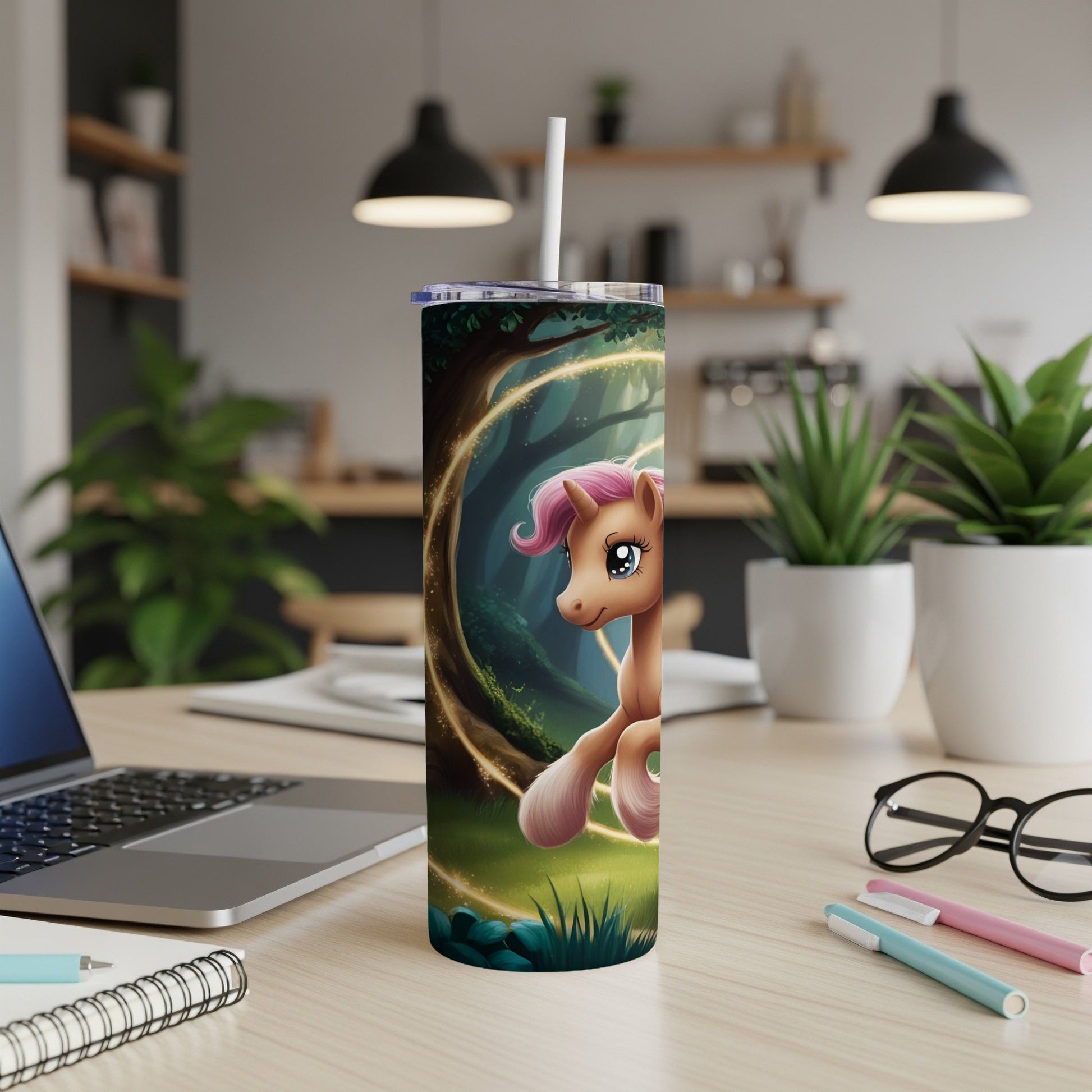 Cartoon unicorn with glowing magical forest background on a skinny tumbler.