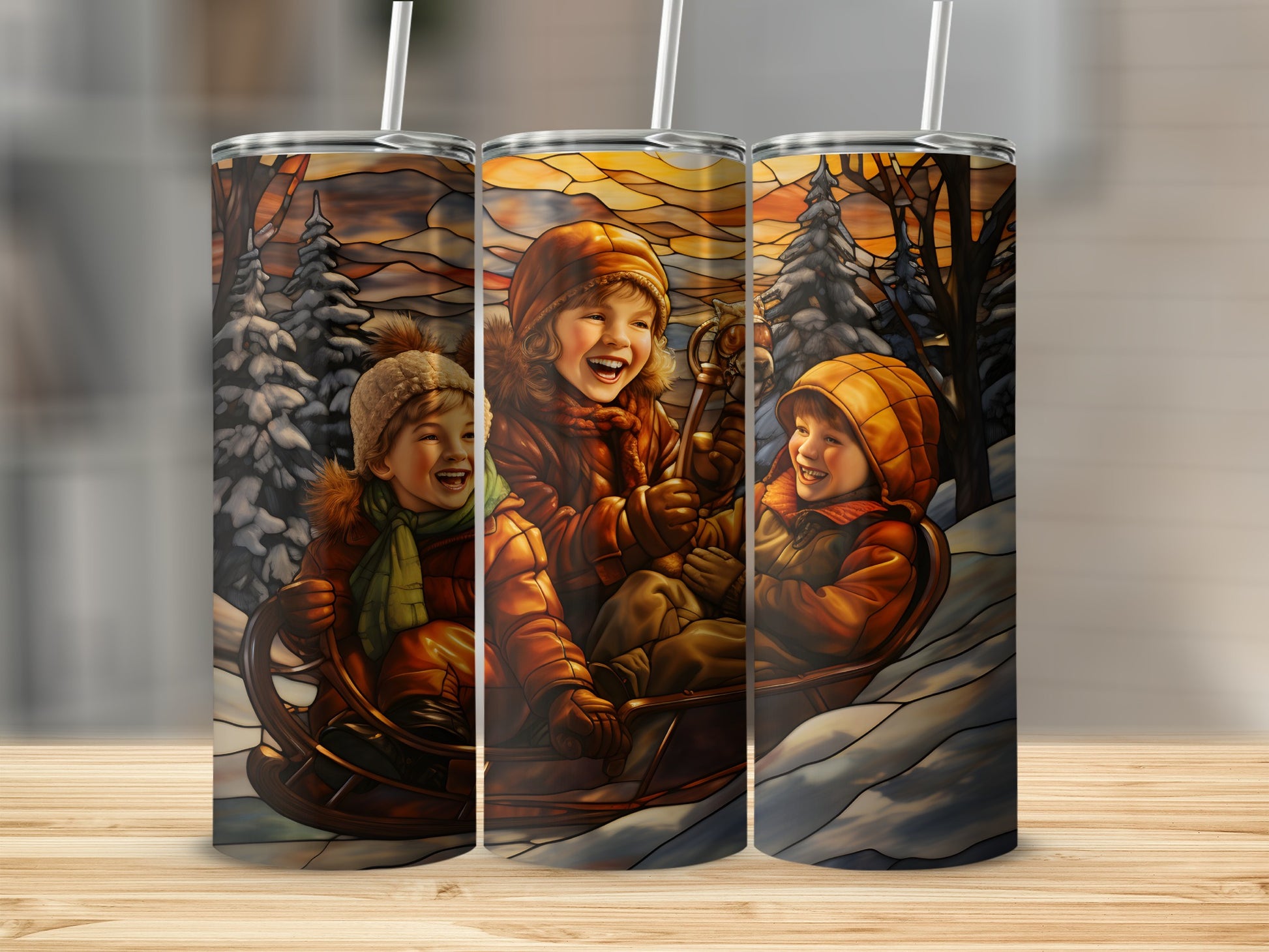 Three tumblers with stained glass art of children on a sled in snow.