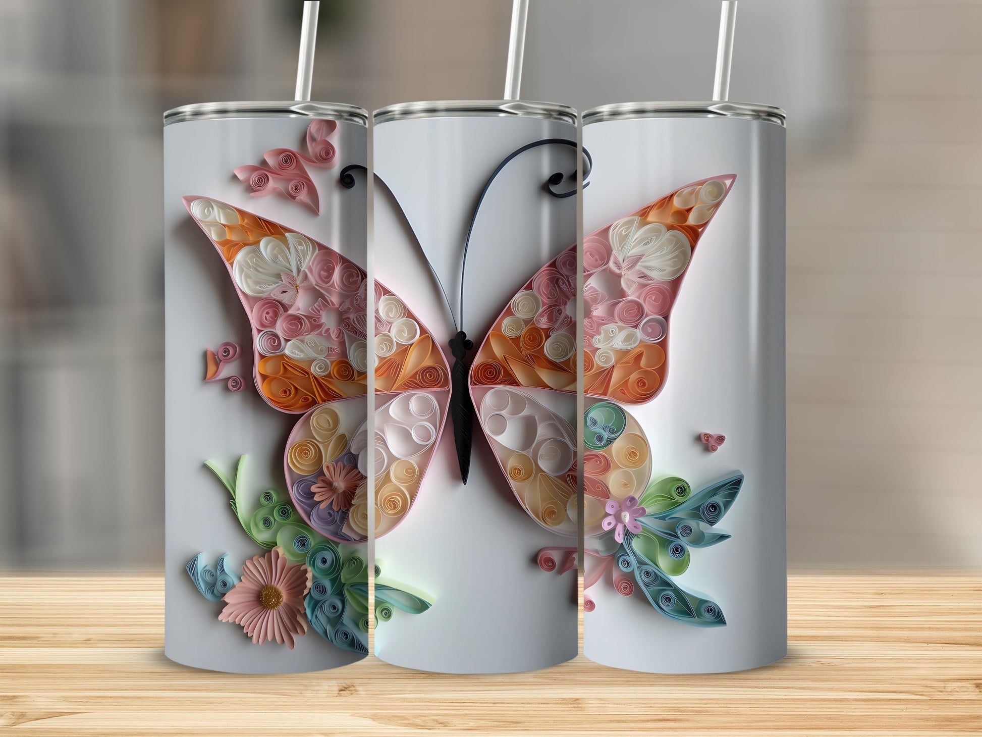 Three tumblers with a pastel butterfly design made from quilled paper.