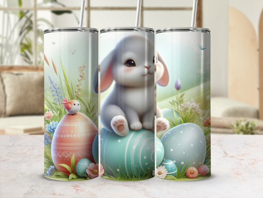 Easter bunny and decorated eggs on a green and blue teal tumbler.