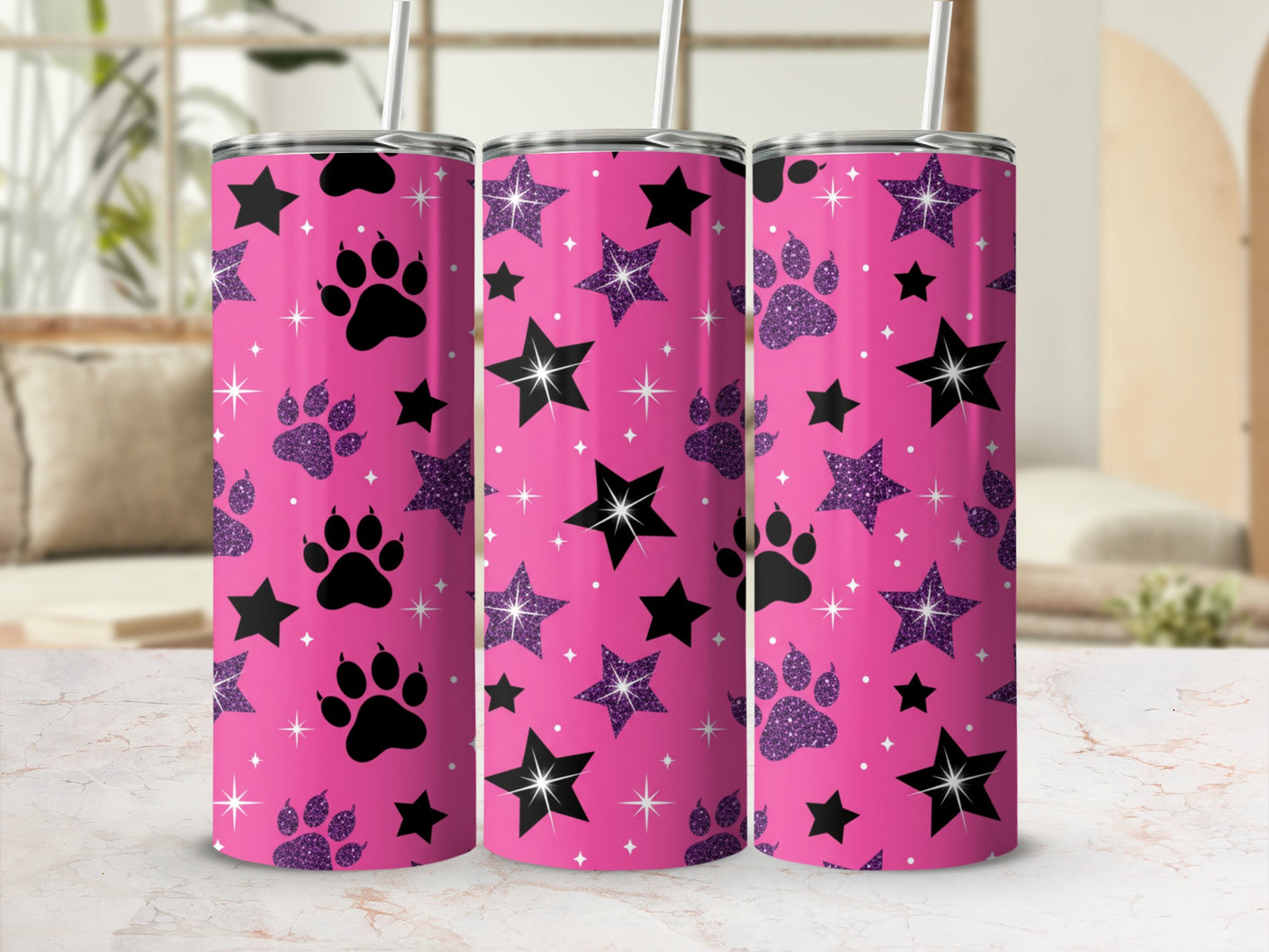 Pink tumbler with black paw prints and stars pattern.