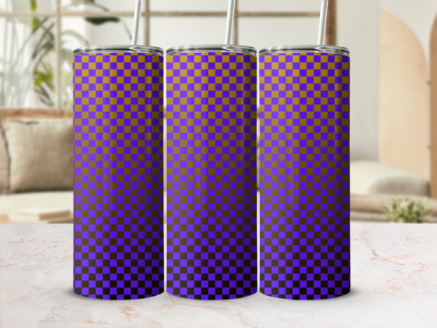 Purple and orange checkered tumbler with straw, on a marbled surface.