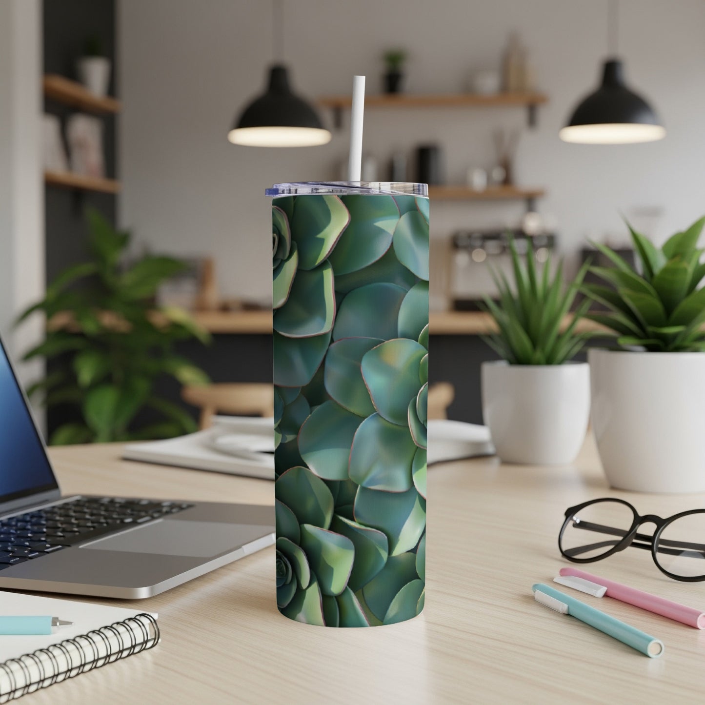 Green succulent pattern on a white tumbler with a straw.