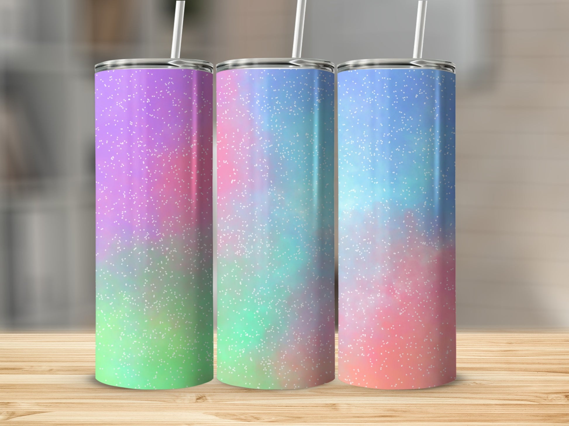 Three tumblers with purple, blue, and pink glitter patterns.