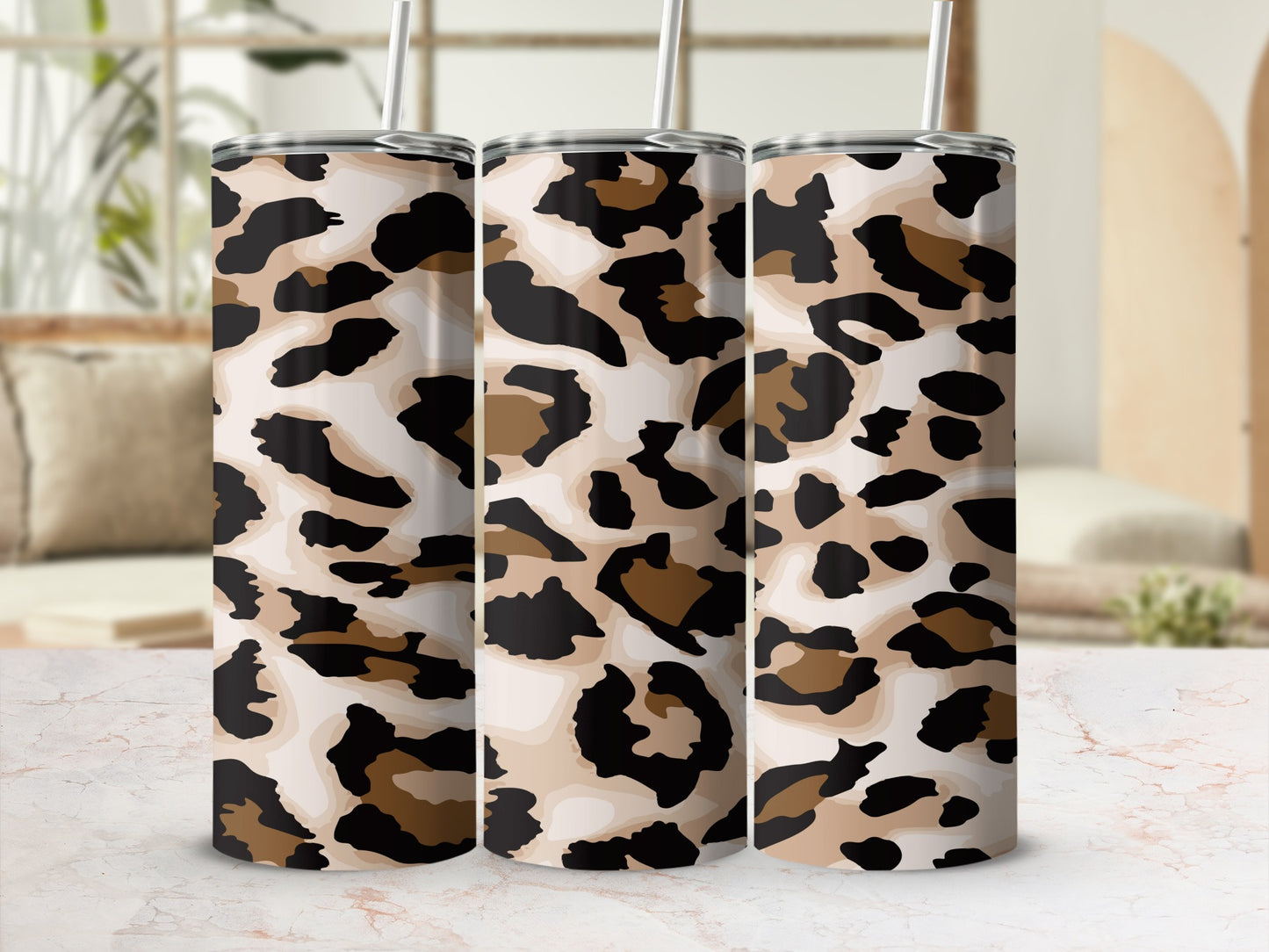 Three tumblers with a neutral leopard print pattern and white straws.