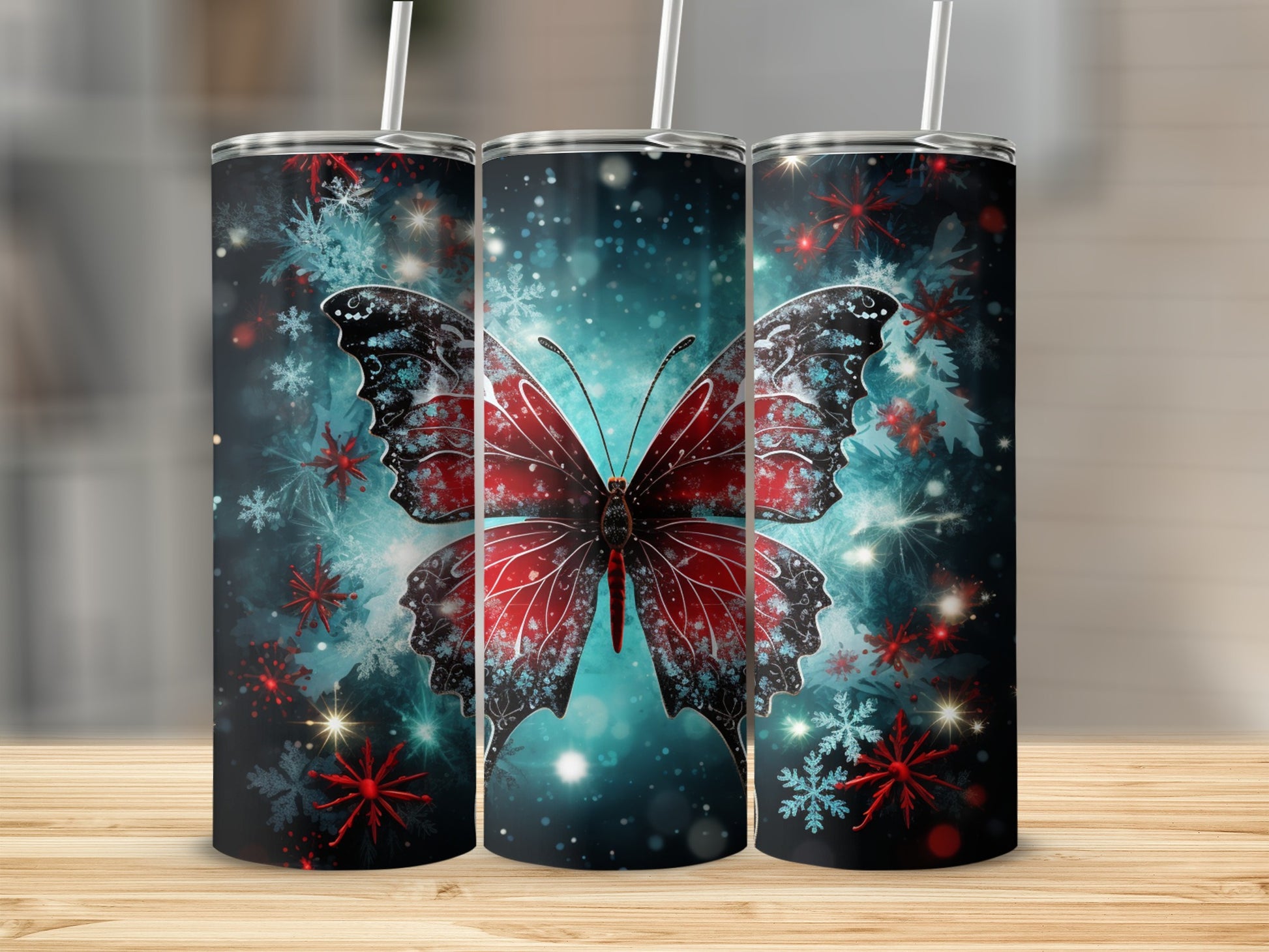 Three tumblers with a red and blue butterfly and snowflake design.