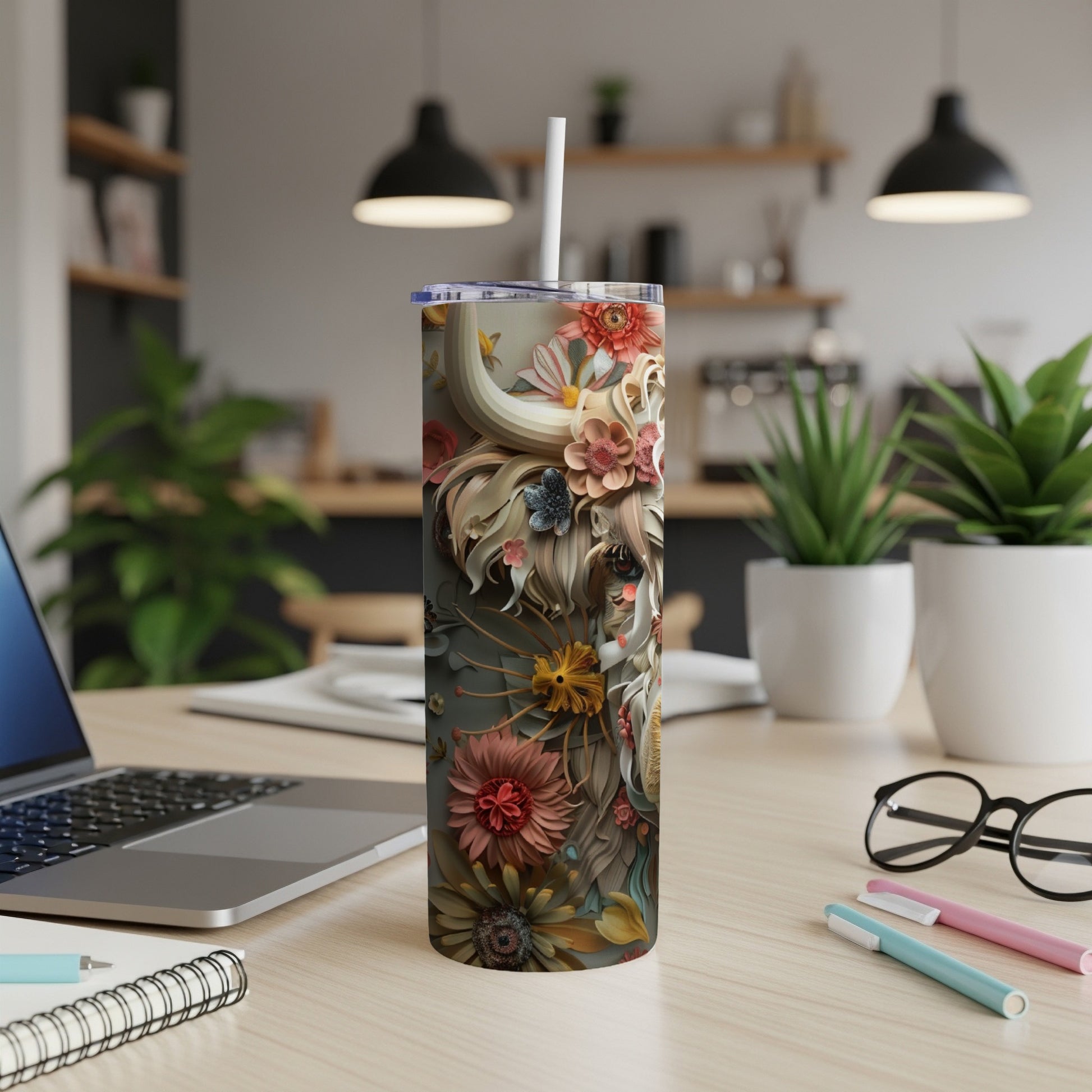 Tumbler with floral and animal-inspired design on a desk.