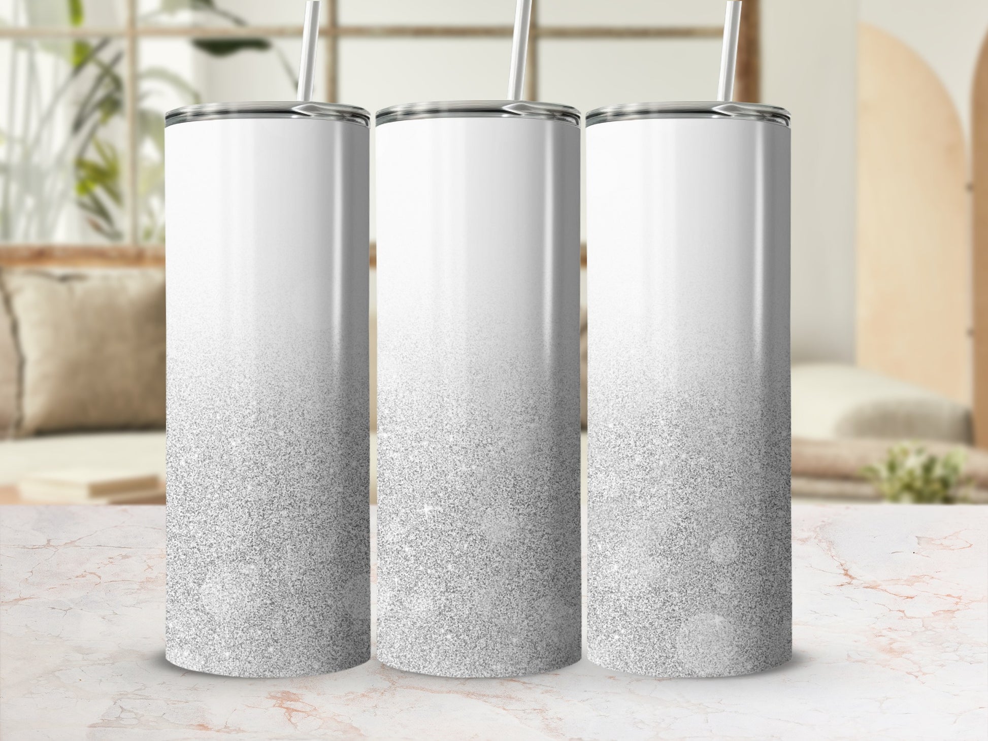 Three white tumblers with silver glitter gradient, on a marble surface.