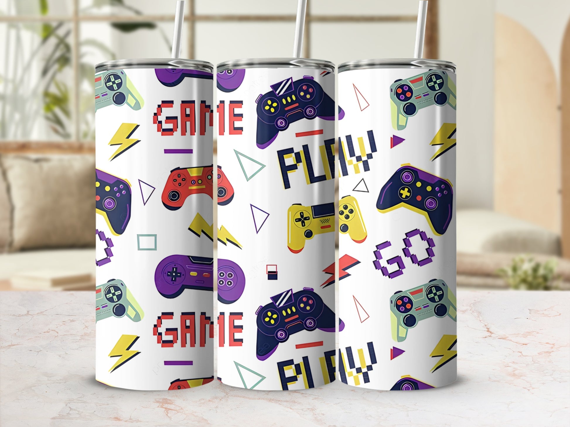 Game controllers and lightning bolts pattern on three tumblers with straws.