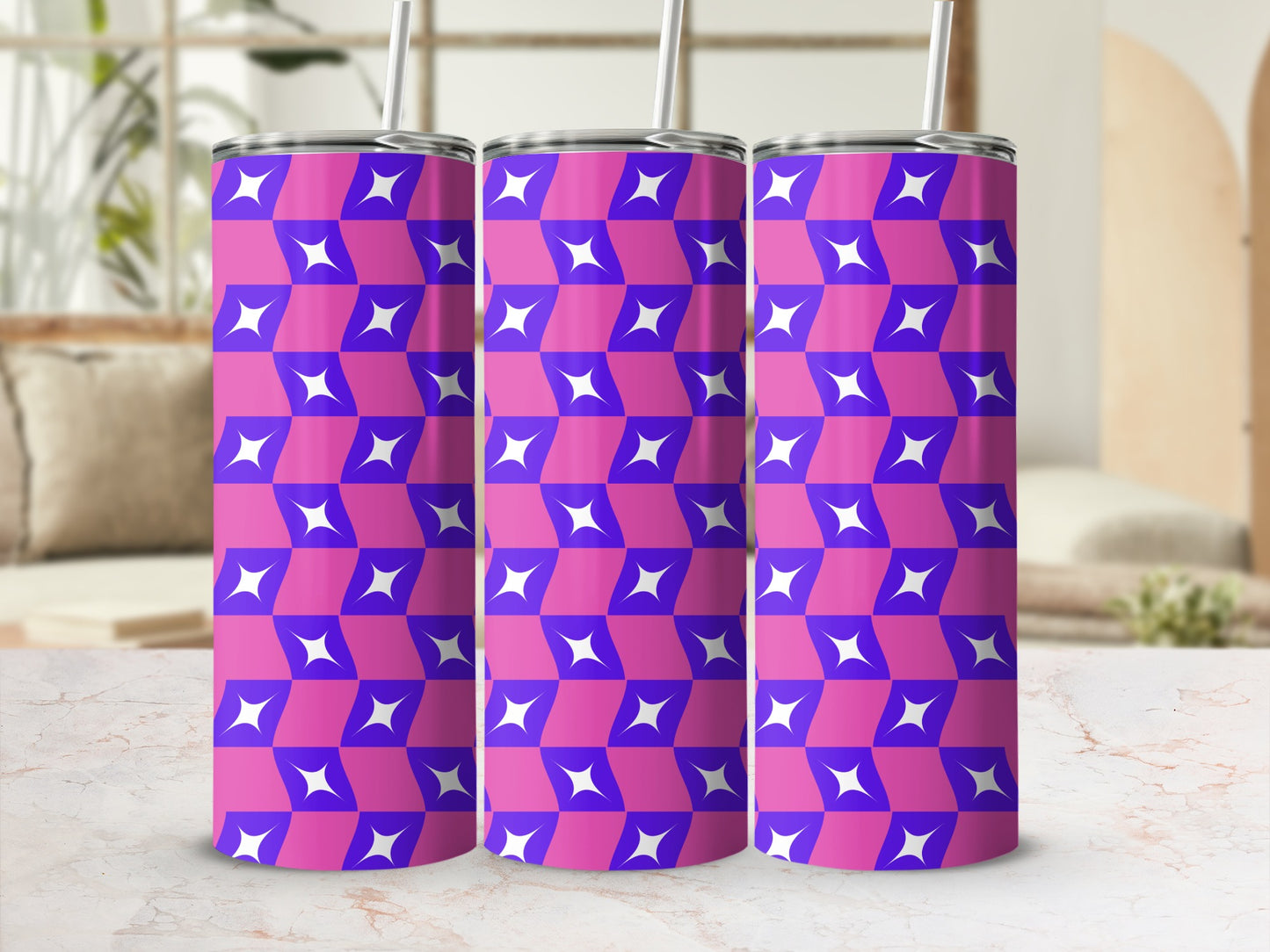 Three purple and pink geometric pattern tumblers with straws.