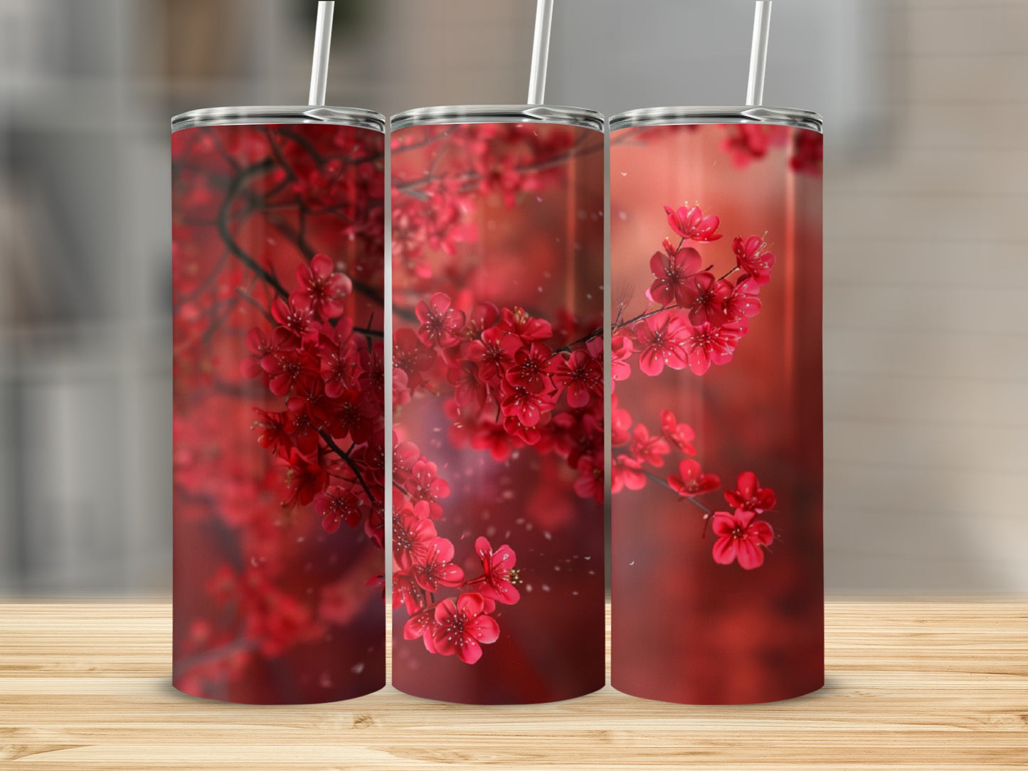 Three tumblers featuring red cherry blossoms and a wooden surface background.
