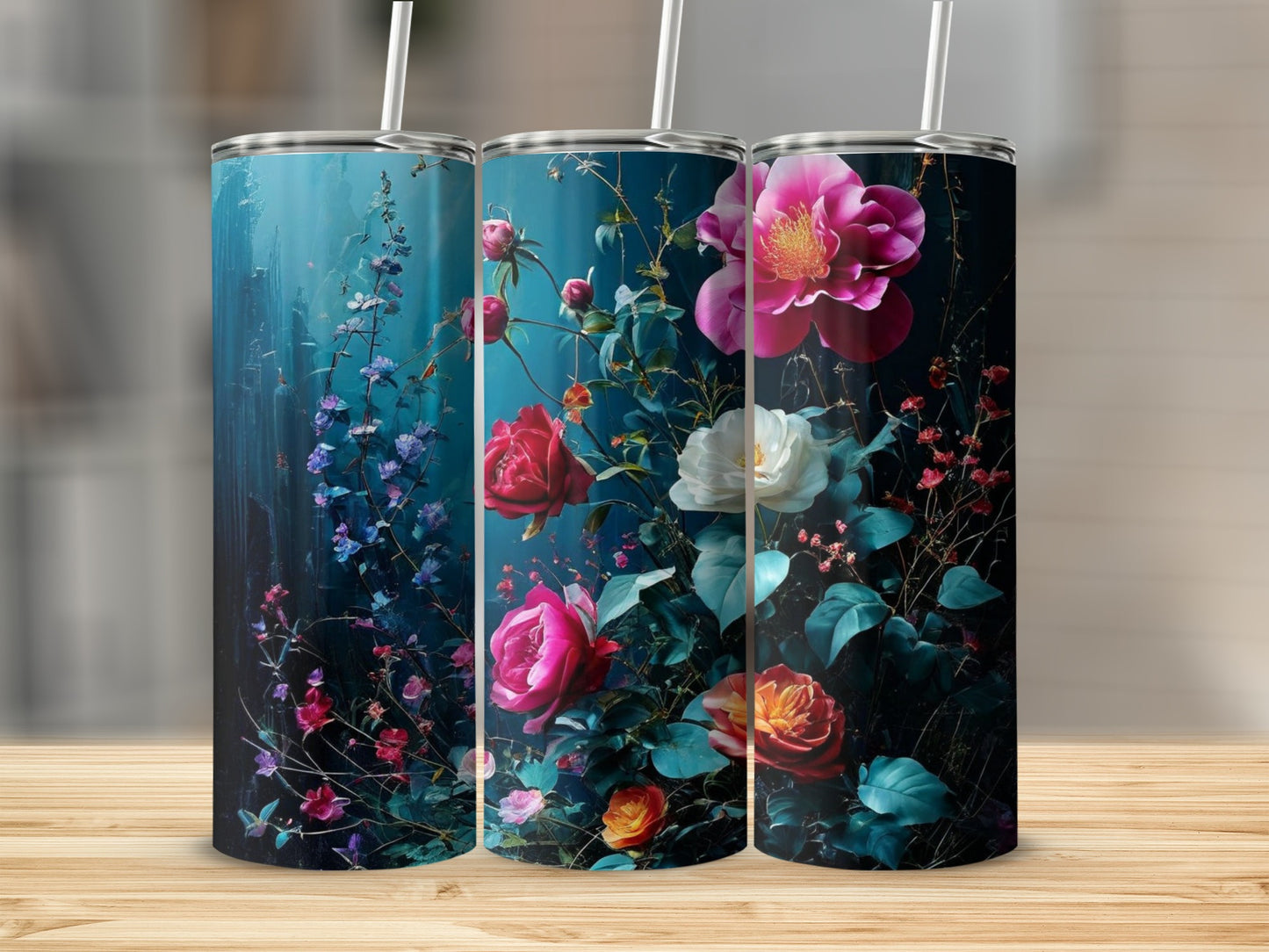 Three tumblers with floral designs, featuring roses and blue flowers.