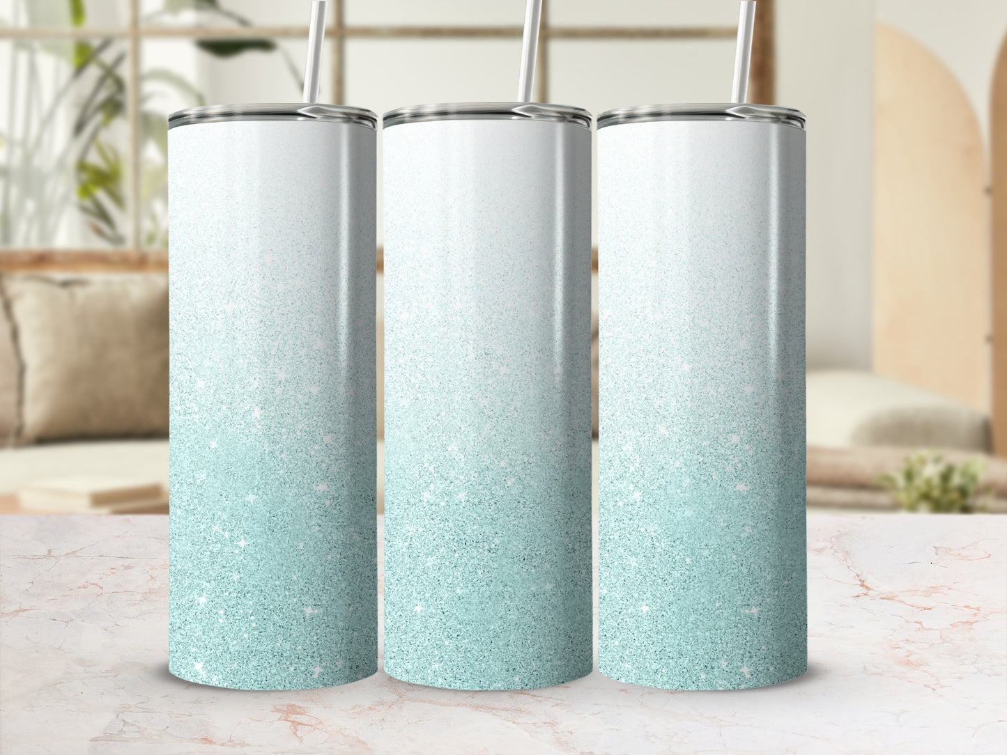 Three tall, shimmering glitter tumblers with straws stand on a marbled surface.
