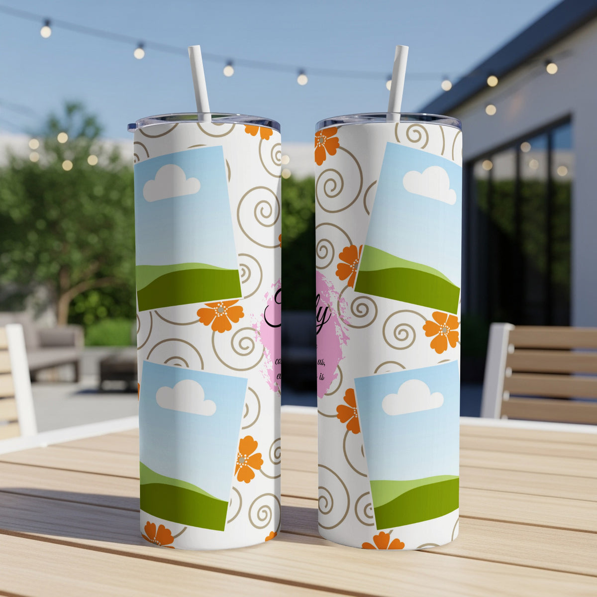 Two tumblers with a sky, clouds, hills, and floral design.
