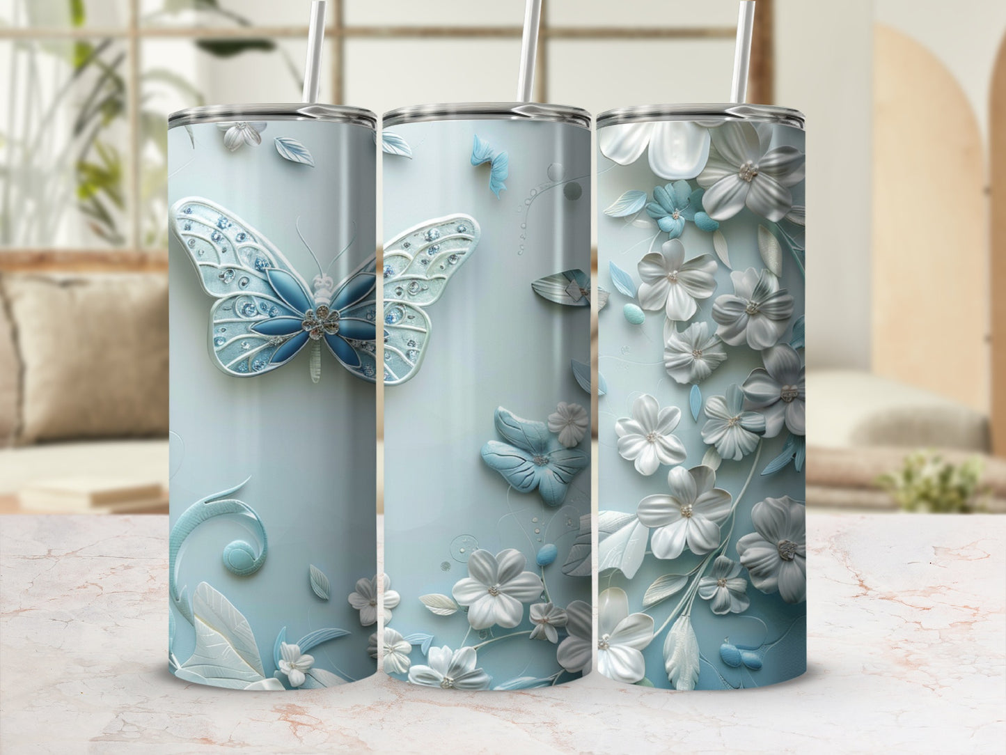 Three light blue tumblers with butterfly and floral designs.