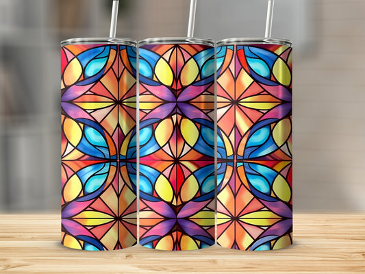 Three tumblers with stained glass floral pattern on wooden surface.