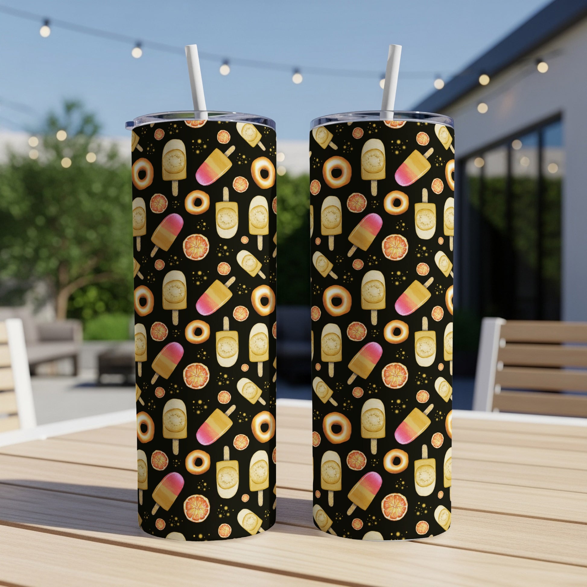 Two tumblers with a repeating pattern of popsicles, donuts, and fruit slices.
