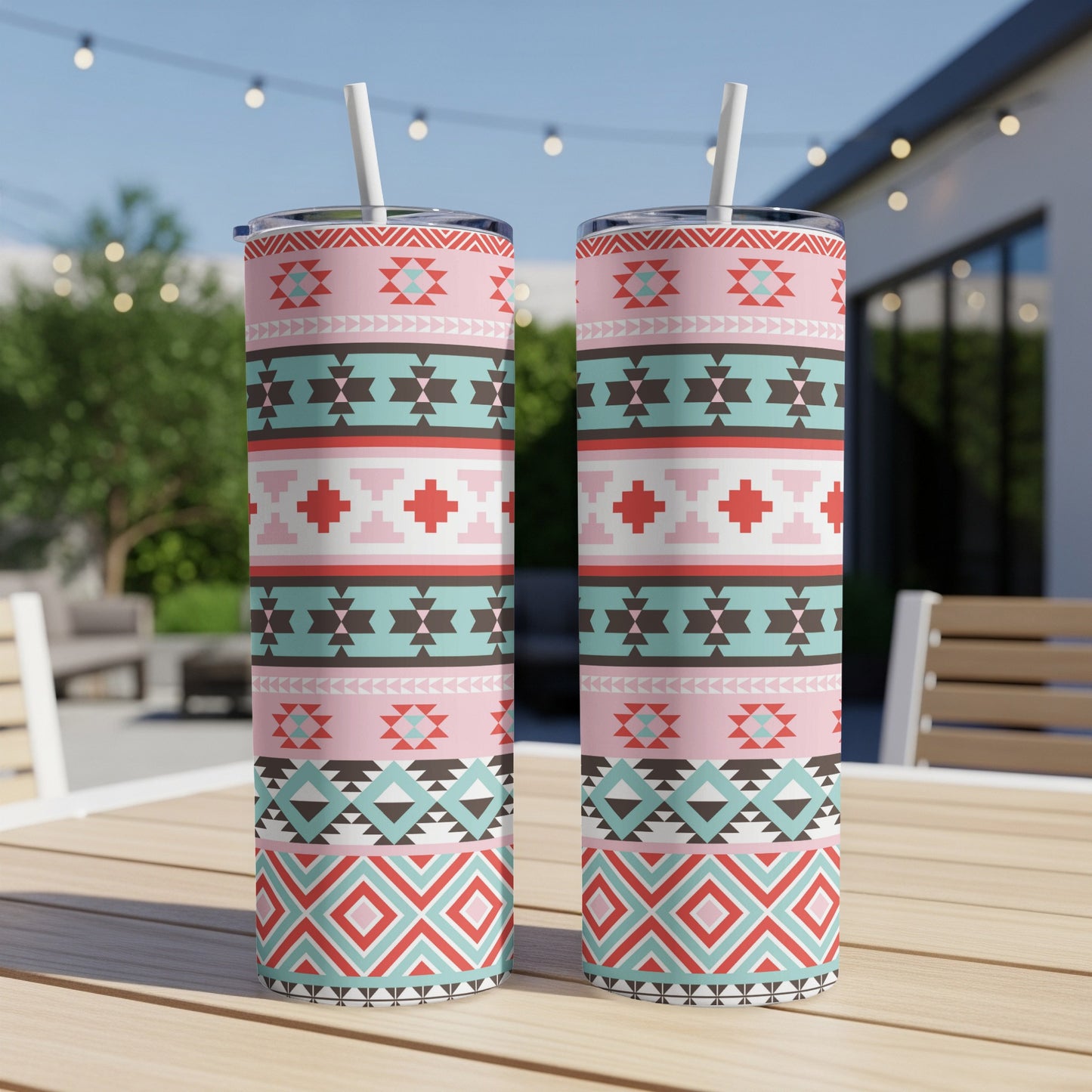 Two tumblers with a Southwestern geometric pattern design and attached straws.