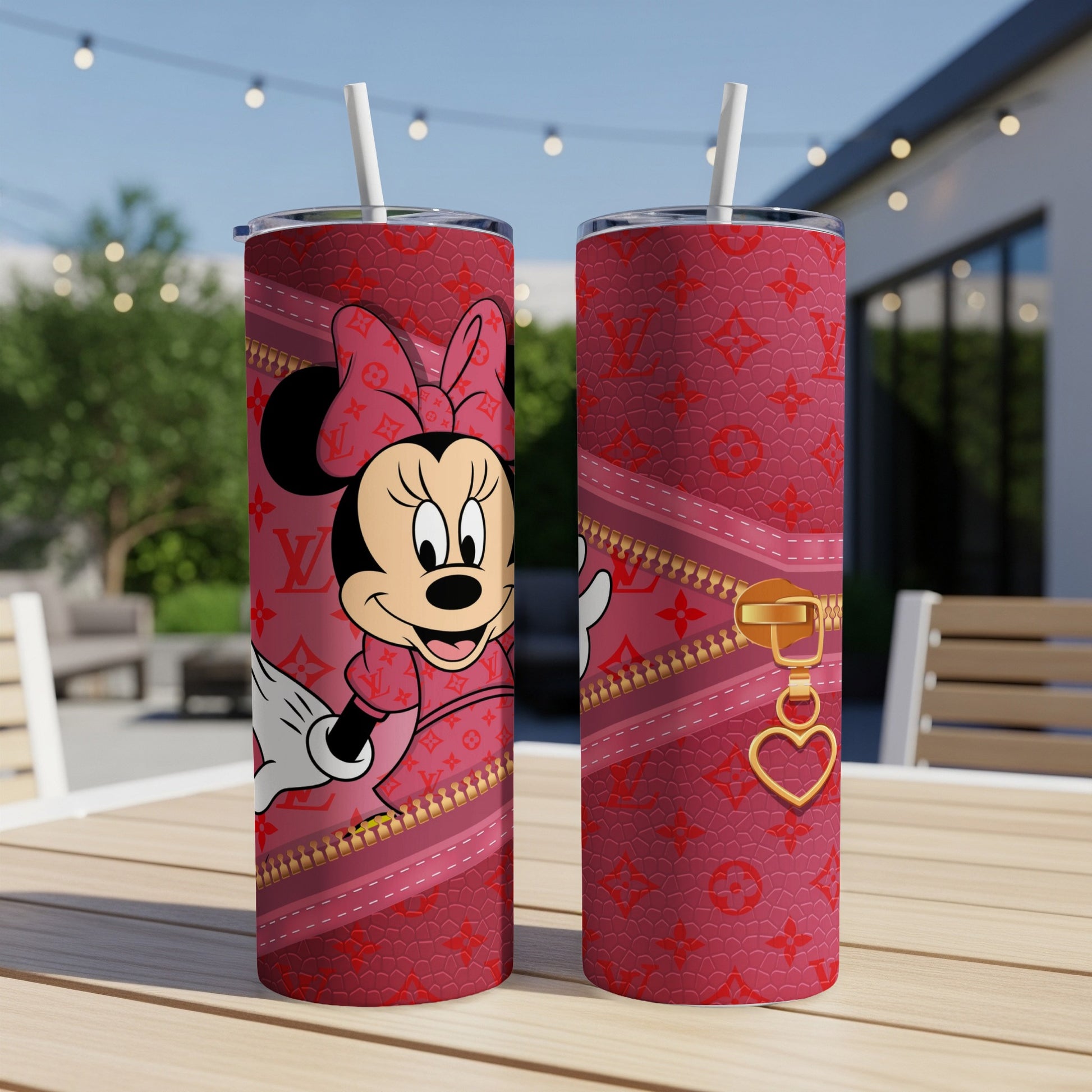 Minnie Mouse design on a pink tumbler with gold zipper and heart charm.