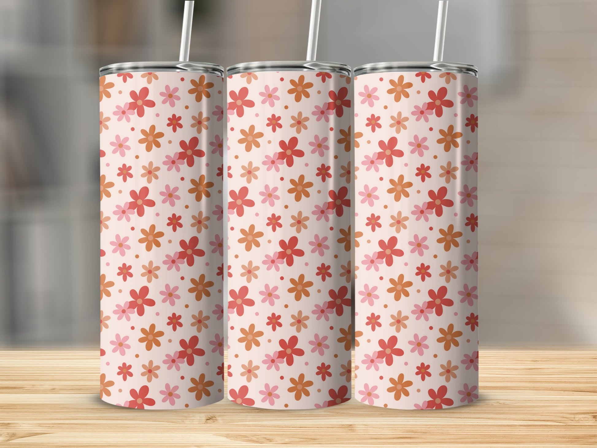 Three tumblers with a repeating pattern of pink and orange flowers.