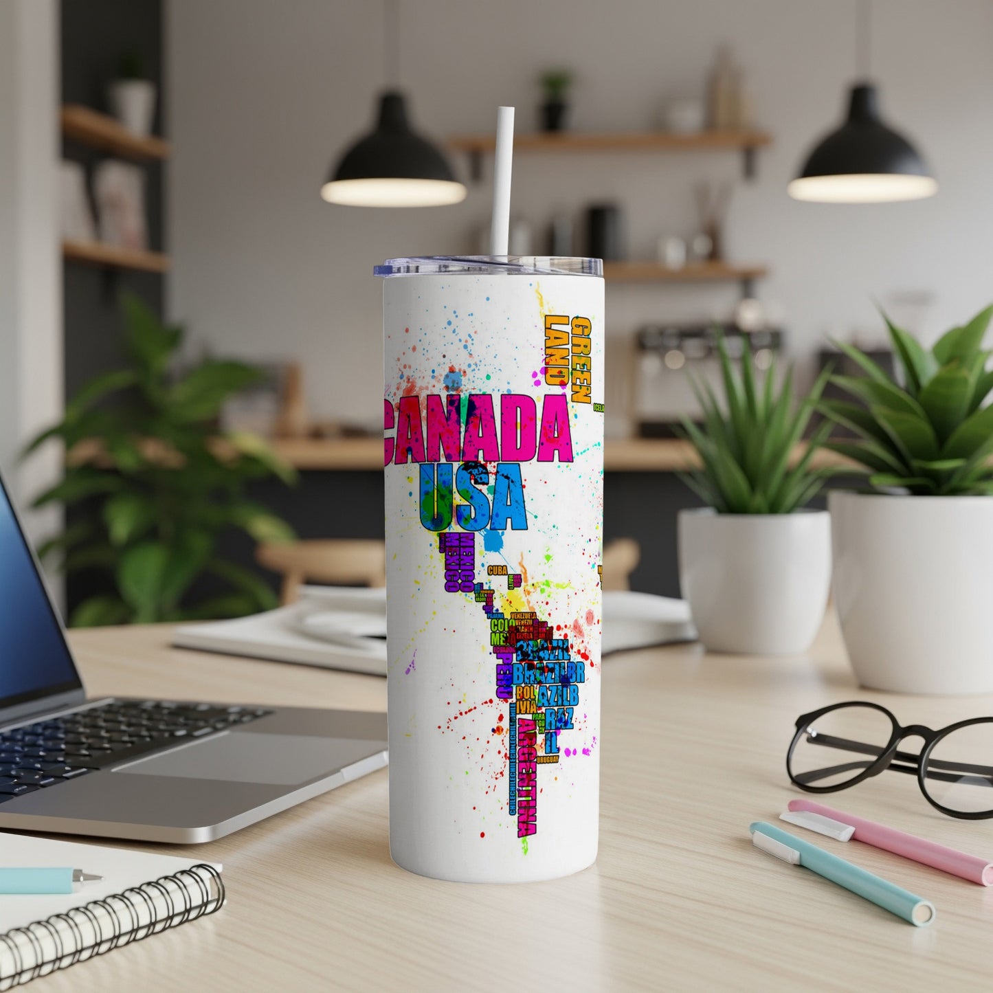 White tumbler with colorful map of the Americas and country names.