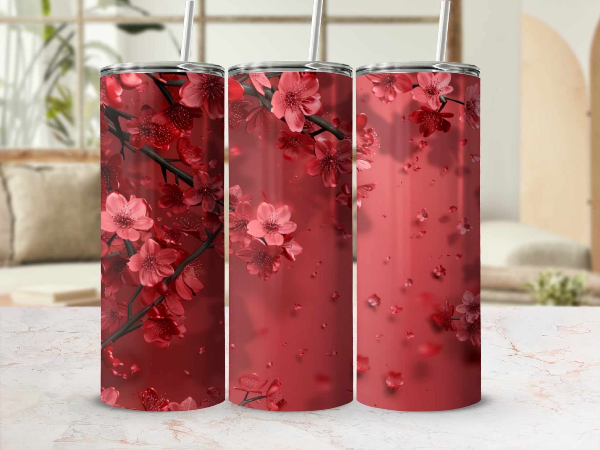 Three red tumblers adorned with blooming cherry blossoms.