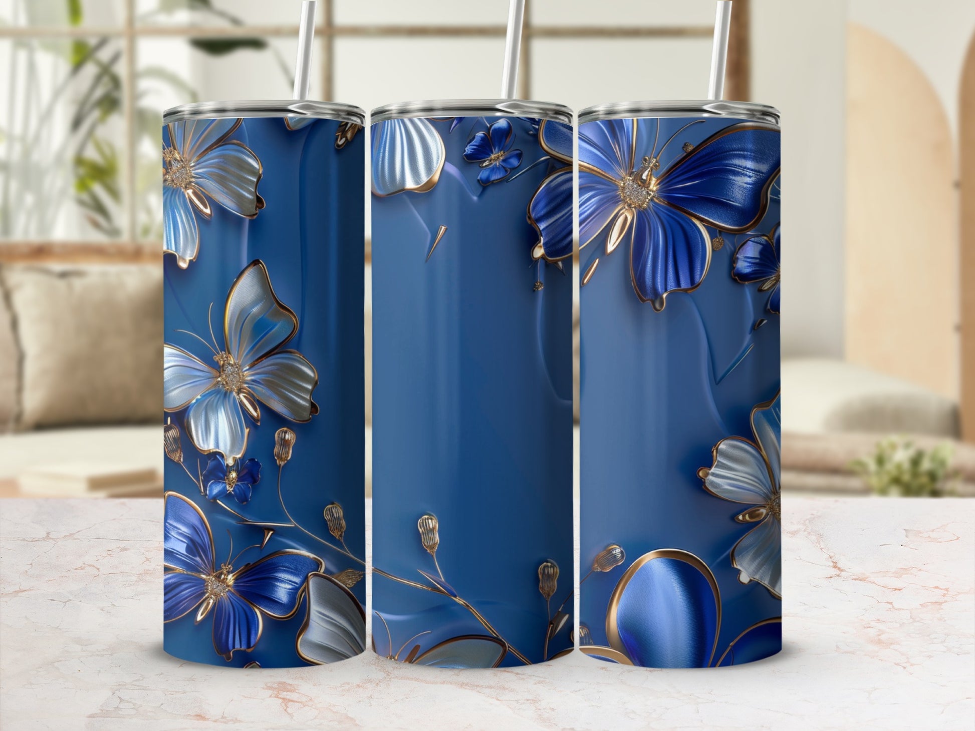 Blue tumblers with ornate silver and blue floral butterfly designs.