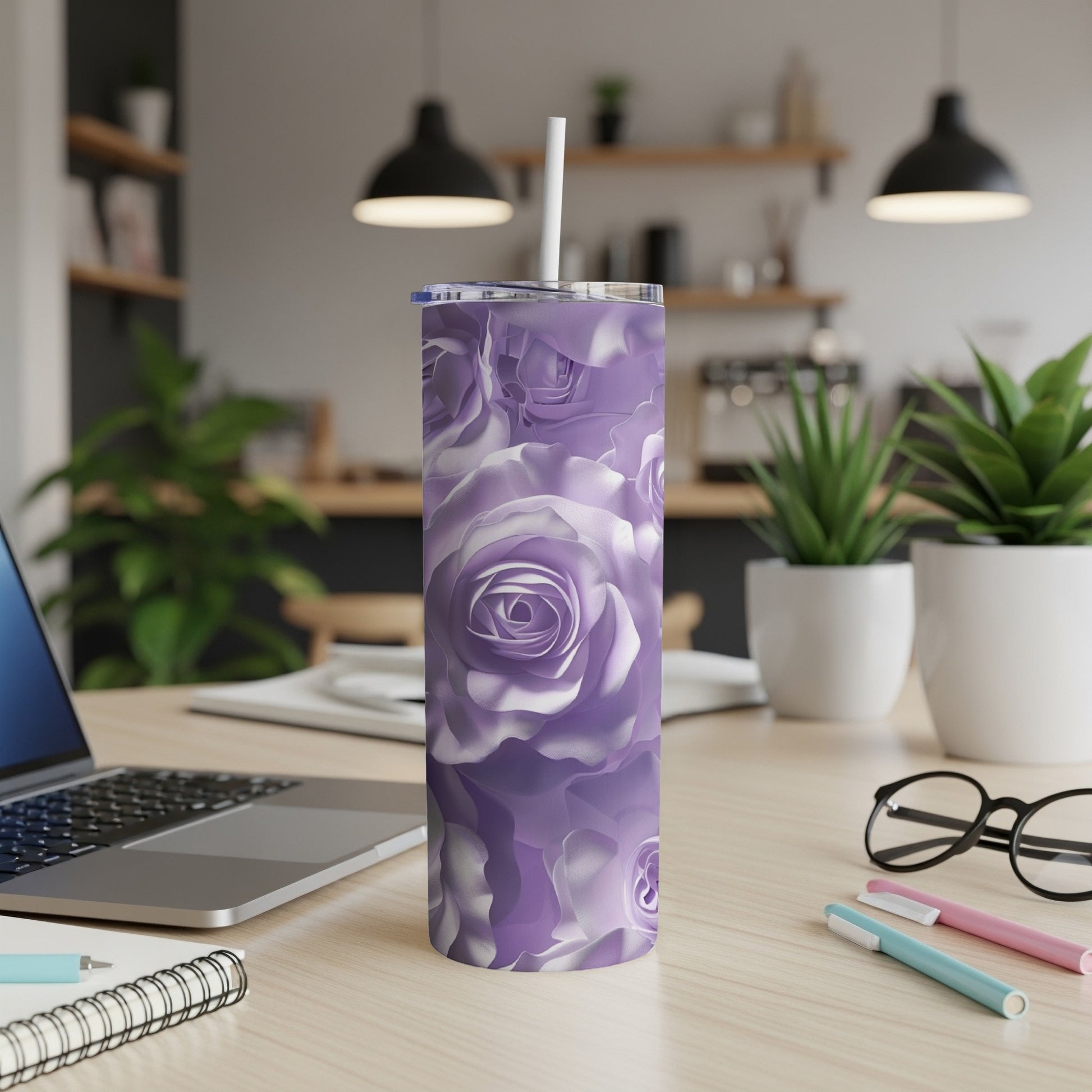 Purple rose floral pattern tumbler with white straw on a desk.
