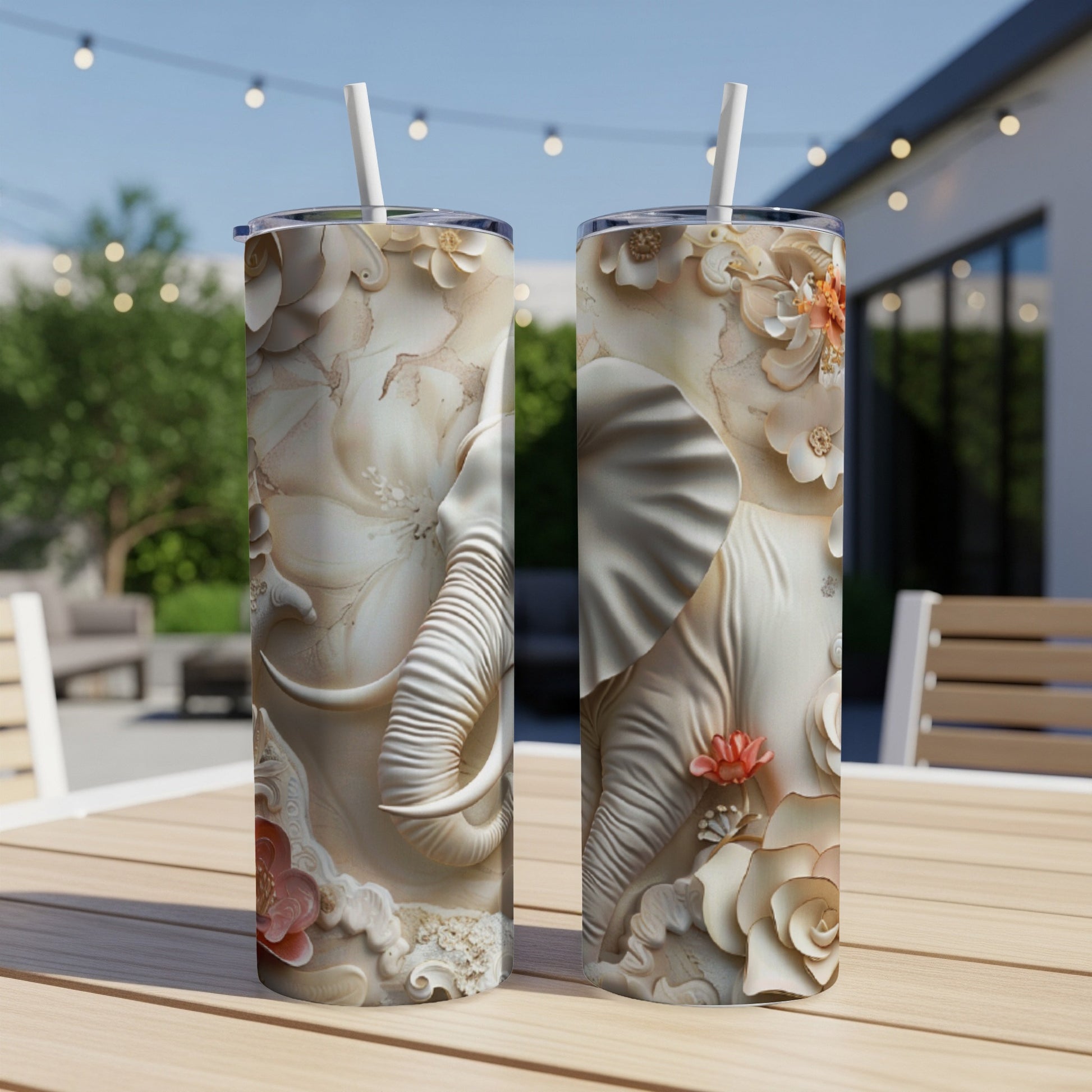 Two white tumblers with embossed elephant and floral designs.