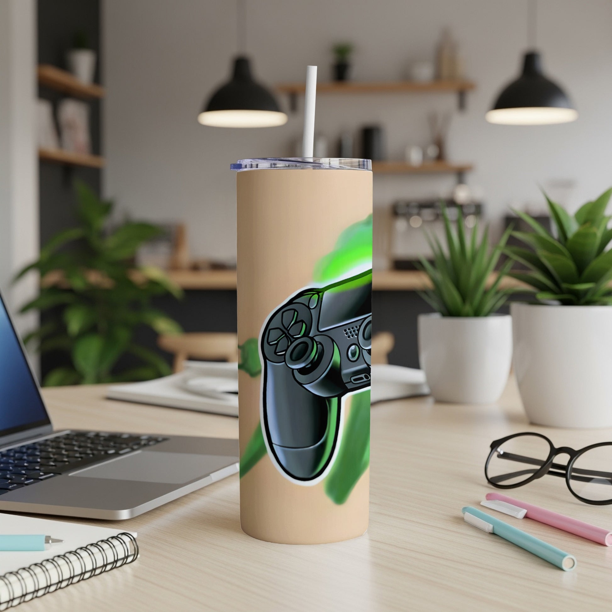 Gaming controller graphic on a tan tumbler with a straw.