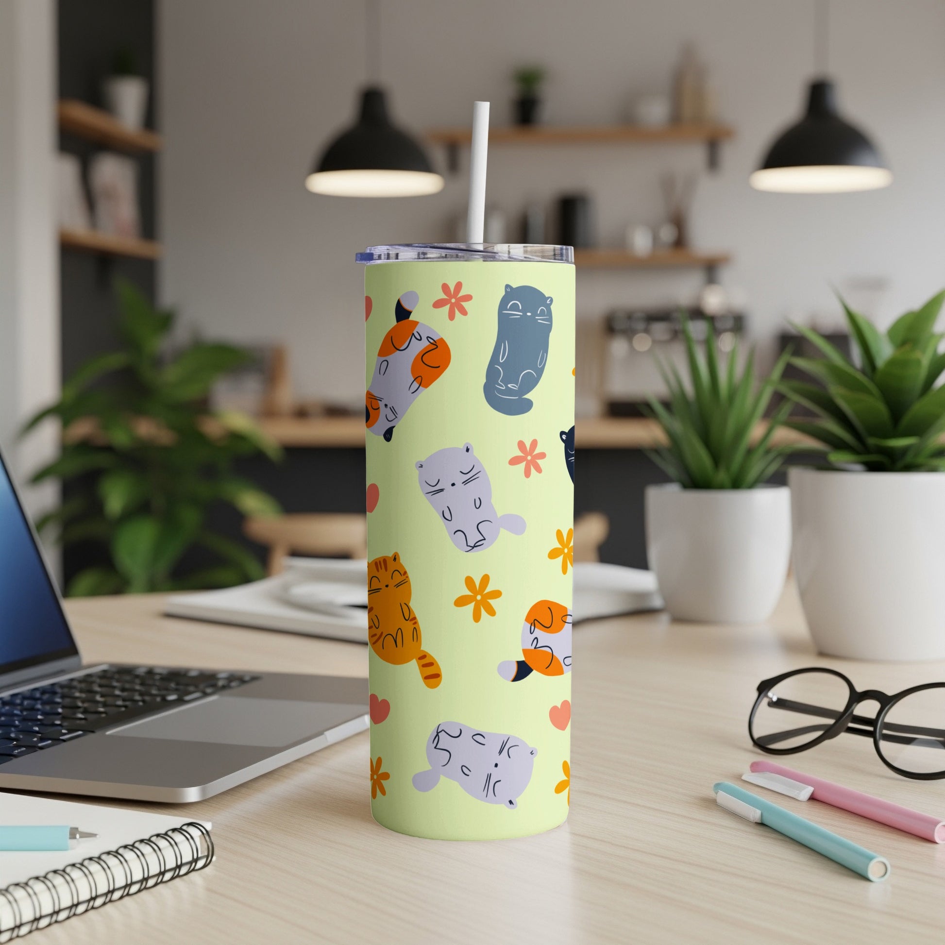Pale green tumbler with cute cartoon cats and flowers.